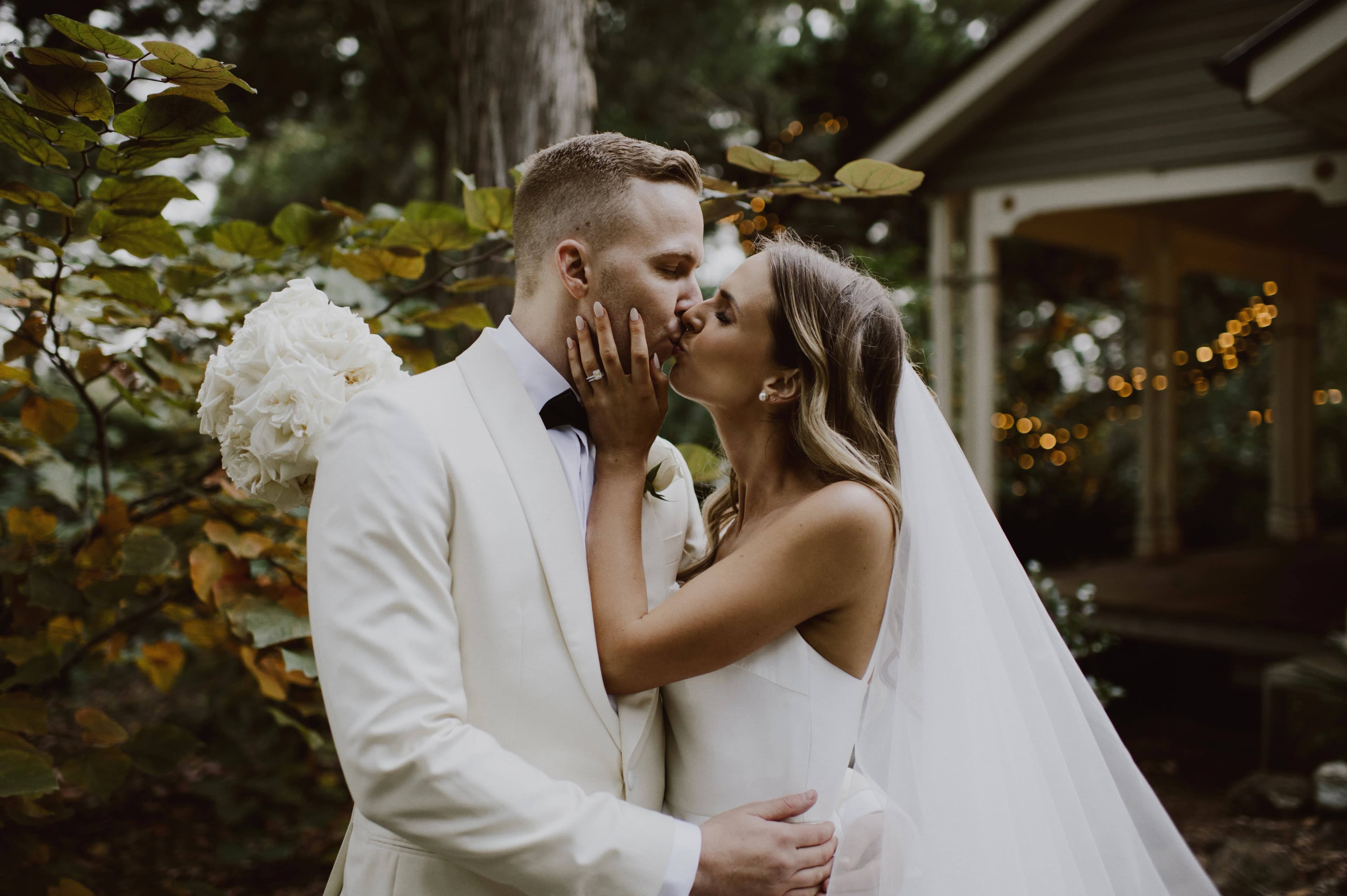 Couple kiss amongst autumn foliage