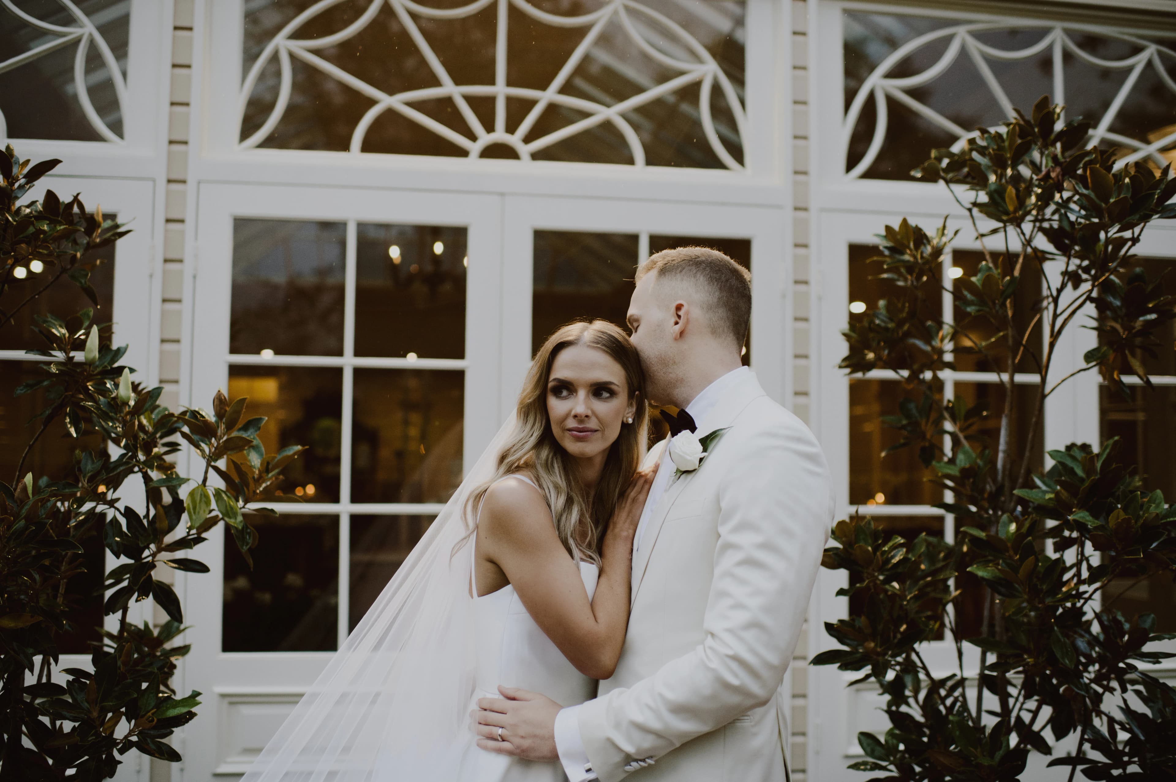 Couple hug in front of glass doors