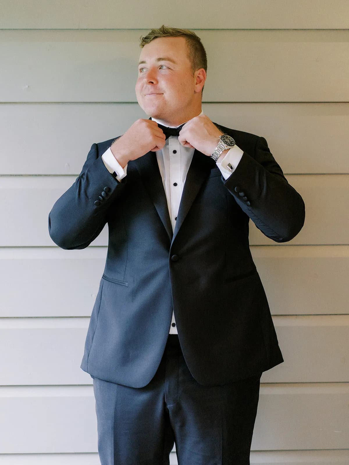 Groomsmen doing up bowtie