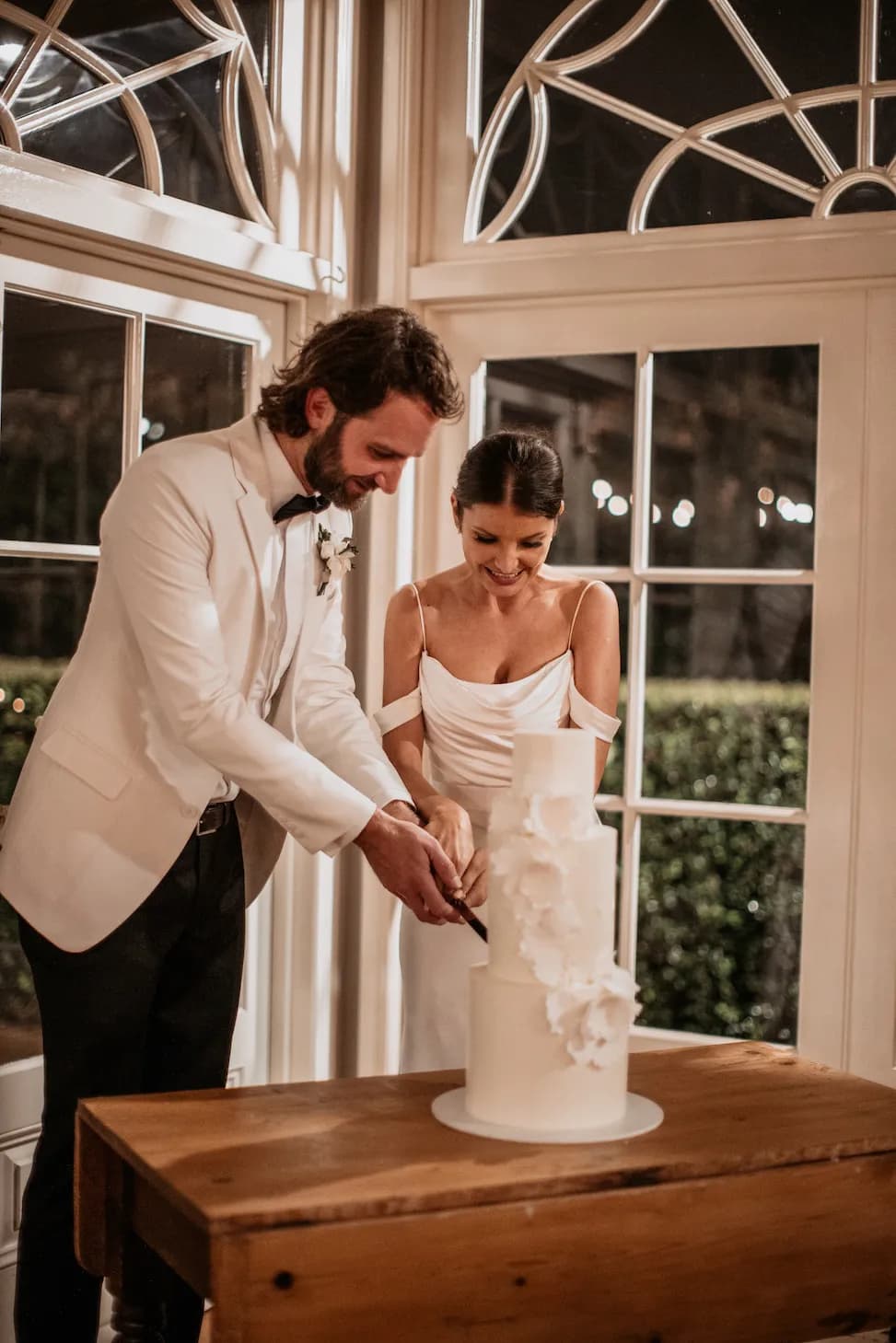 Couple cutting wedding cake