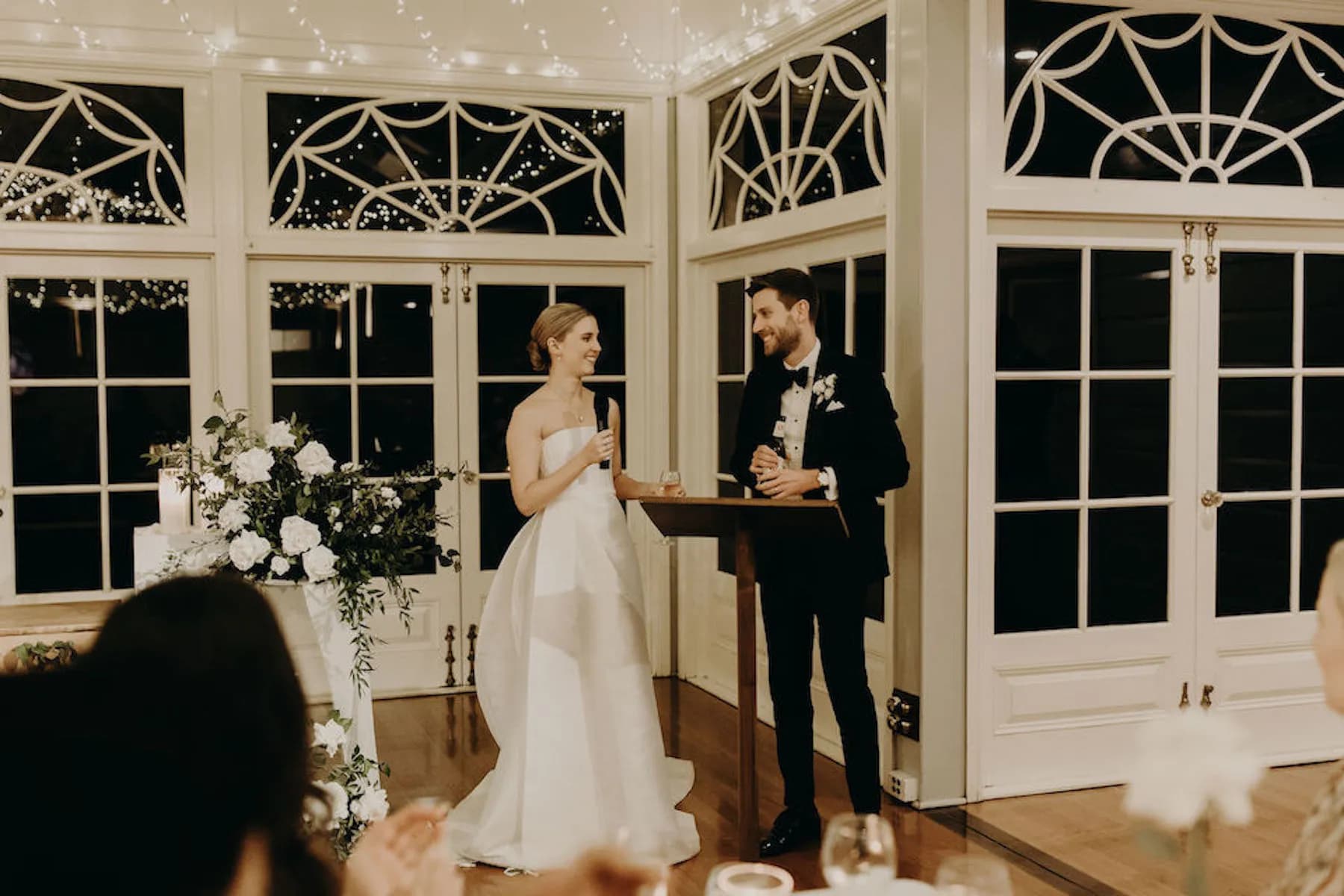 Bride looking at groom giving speech