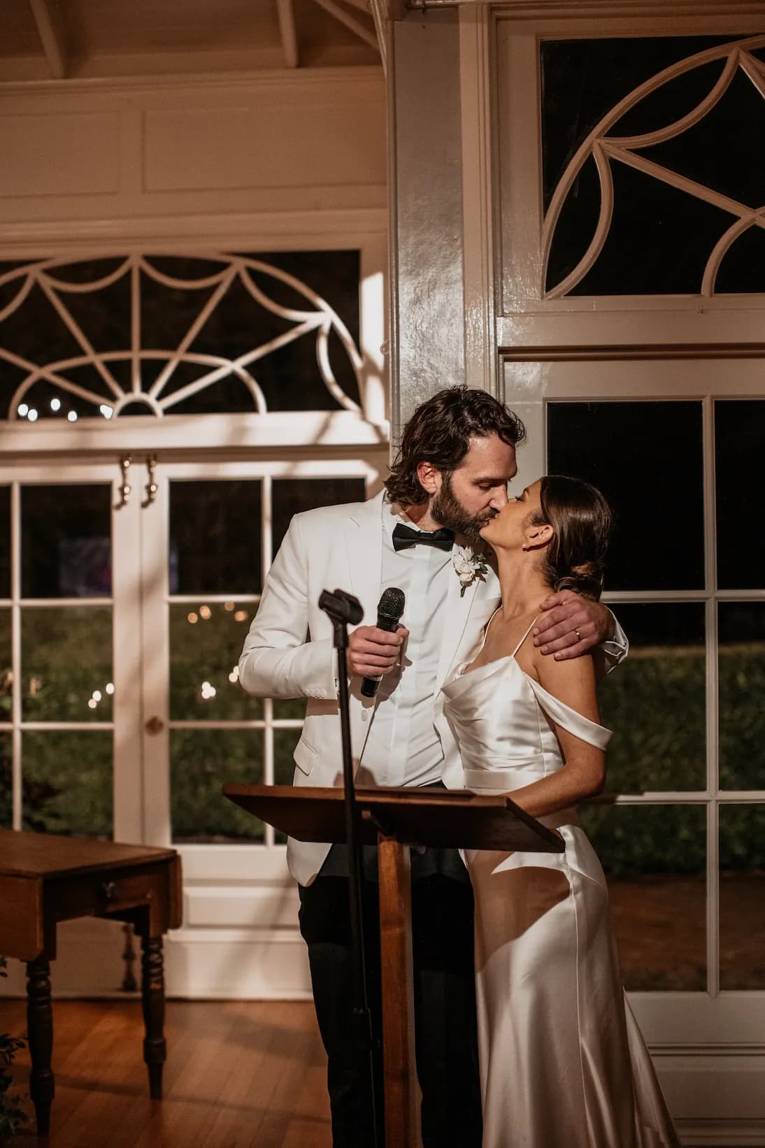 Bride and groom kissing after speech