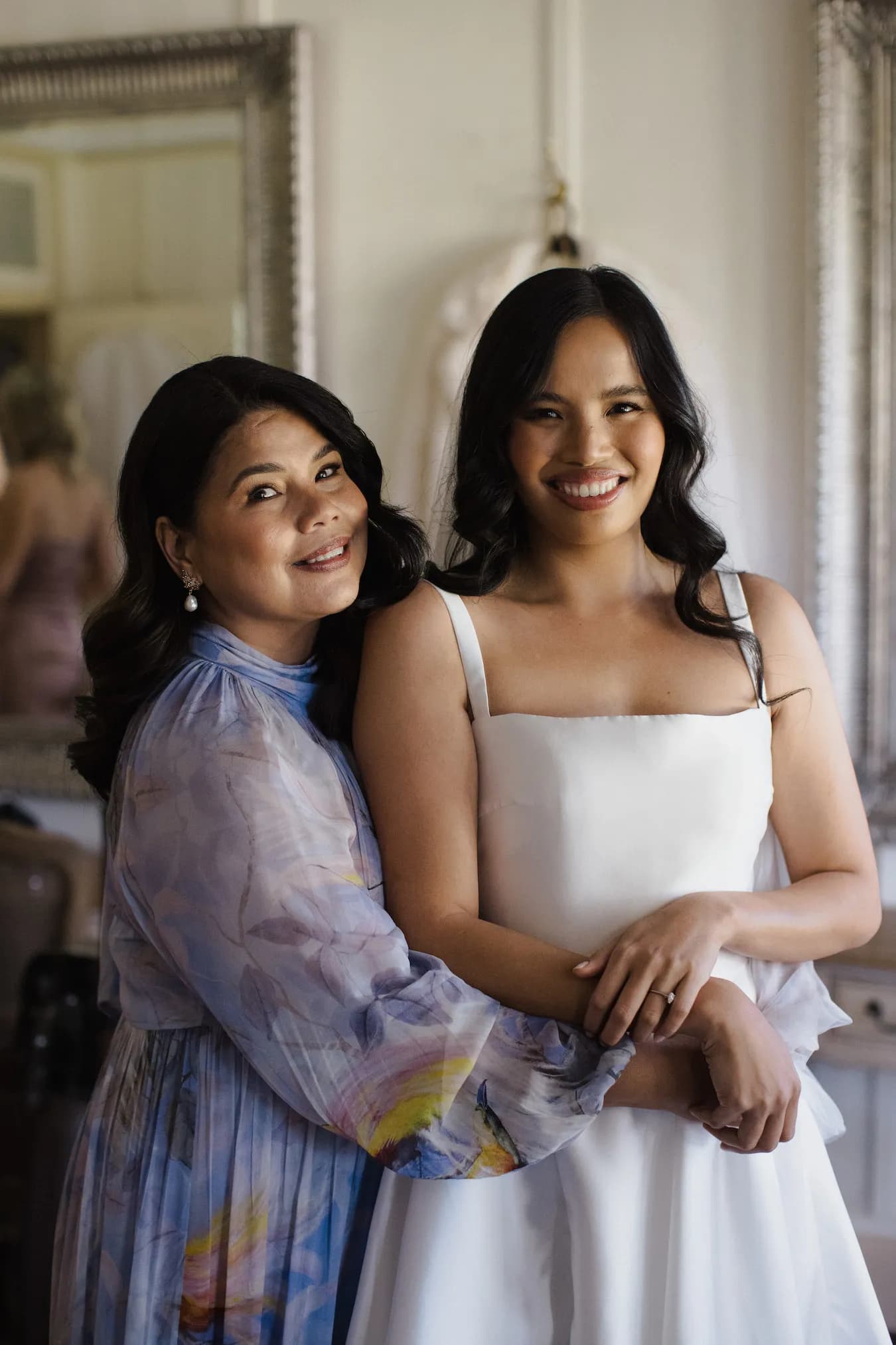 Bride and mother-of-the-bride hugging