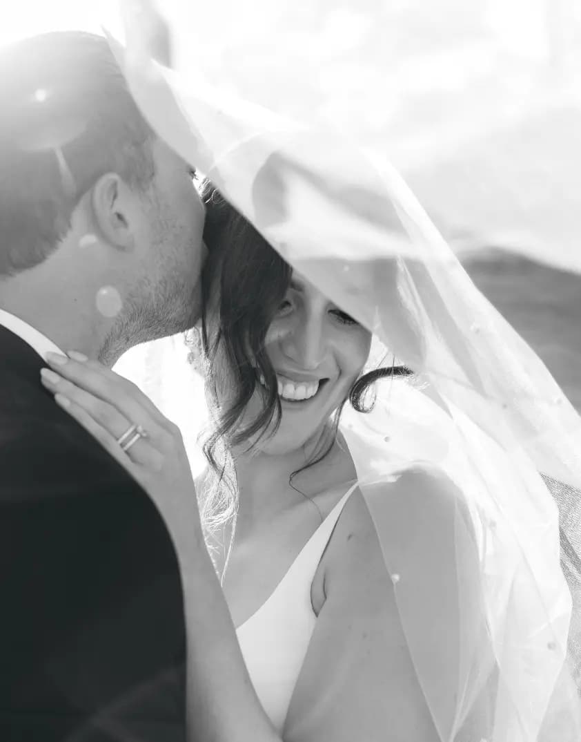 Couple pose under veil