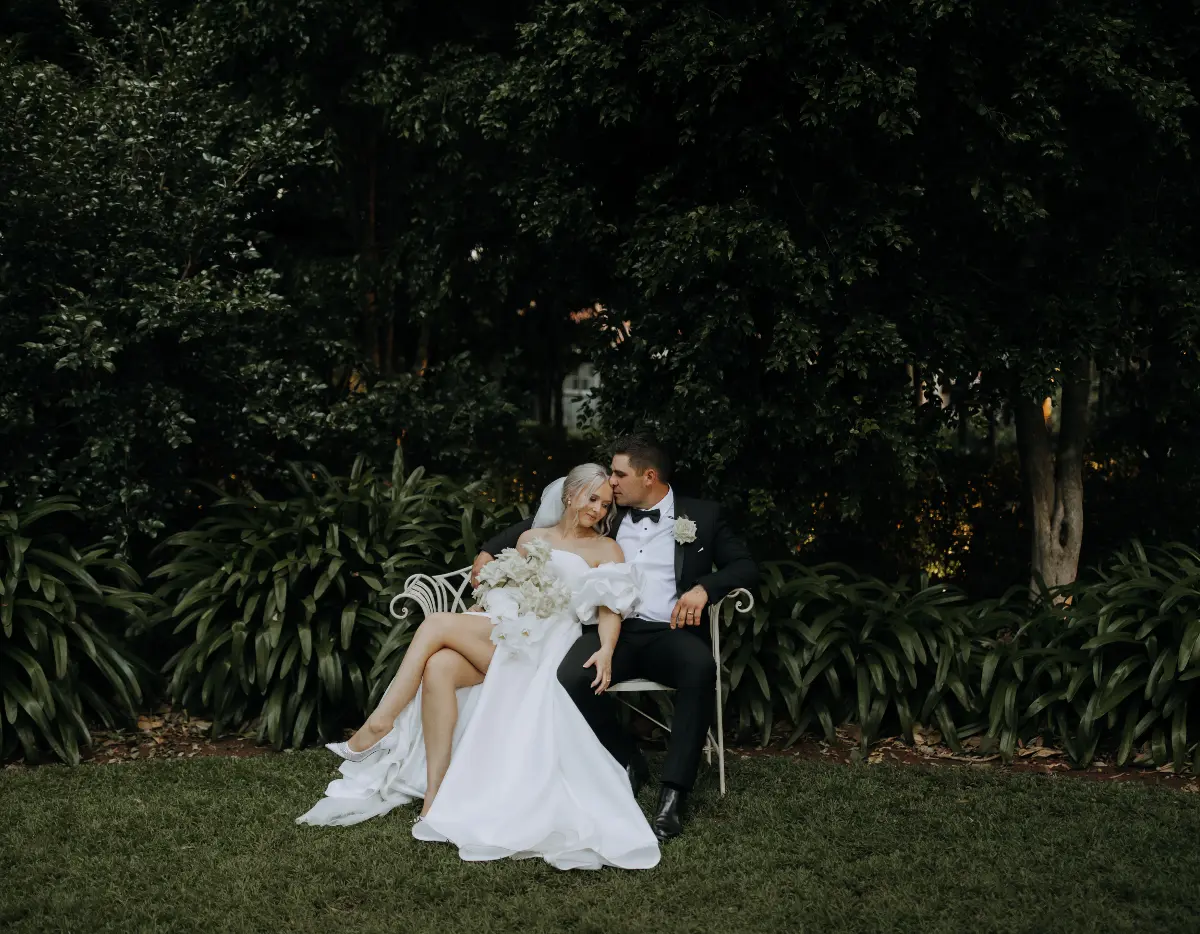 Couple pose on the white garden chair