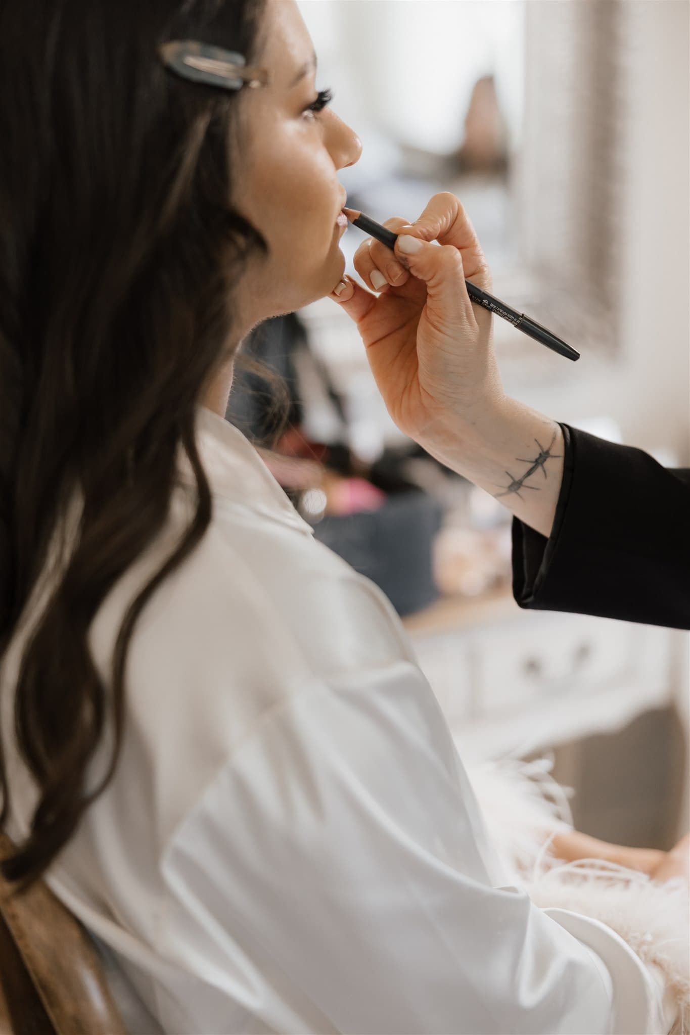 Bride having makeup applied