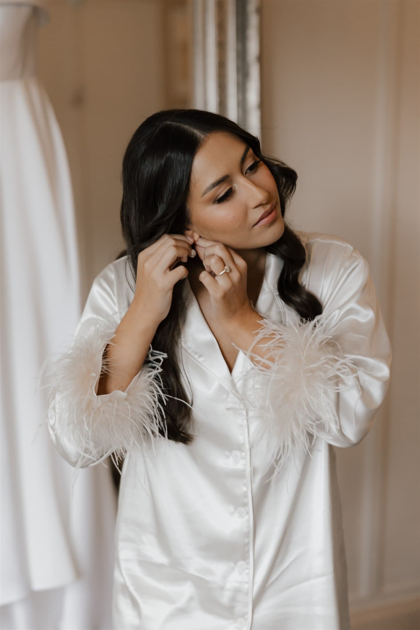 Bride putting in earrings