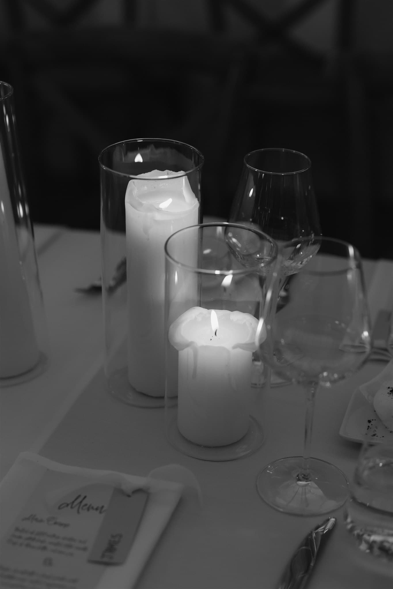 Candles set on a table with glassware