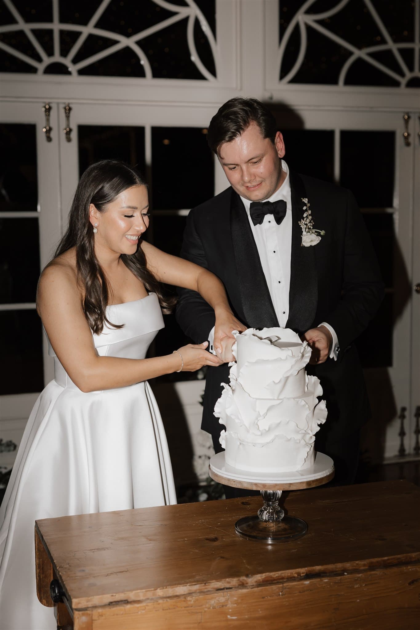 Bride and groom cutting wedding cake