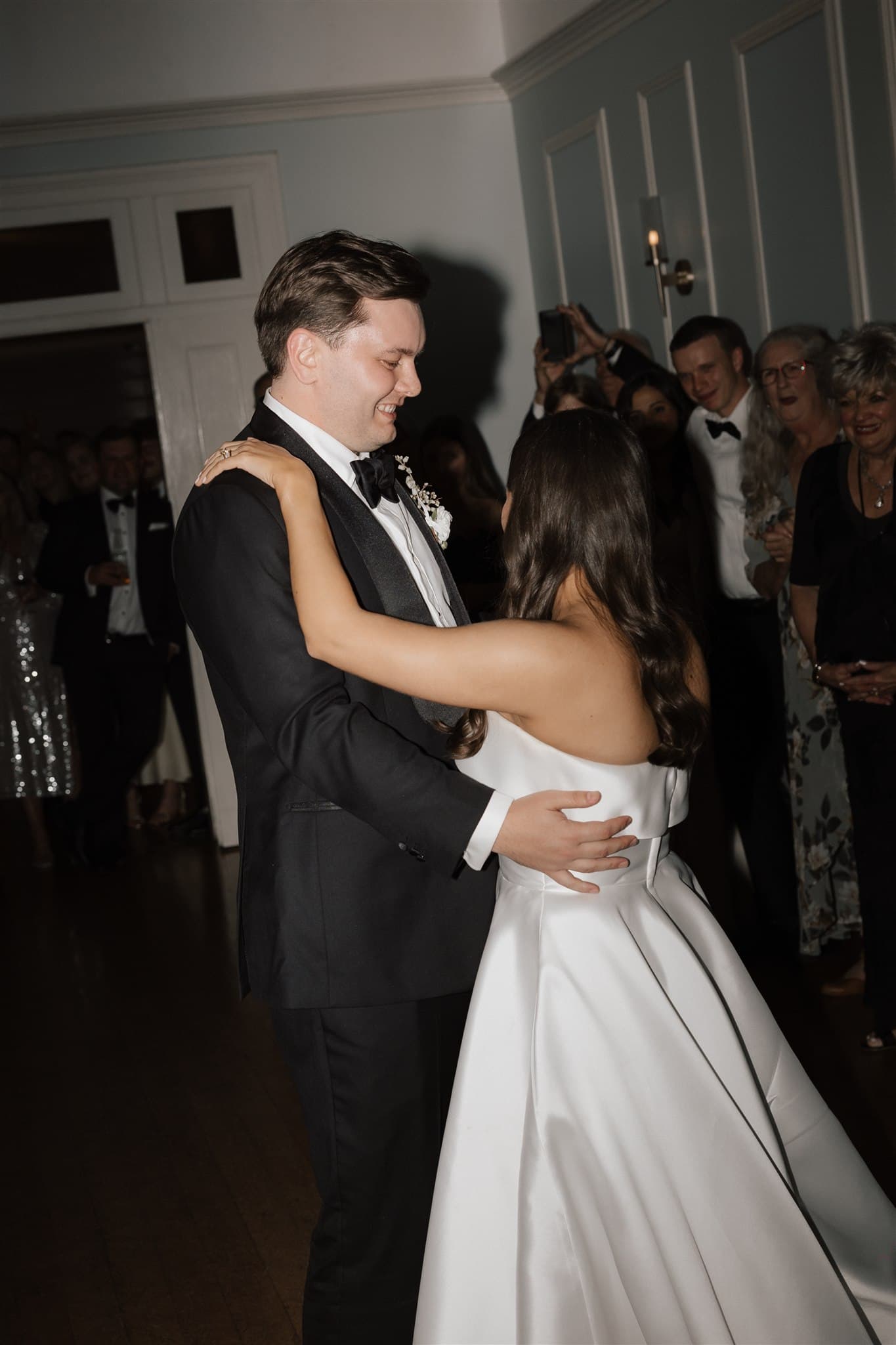 Bride and groom dancing in ballroom
