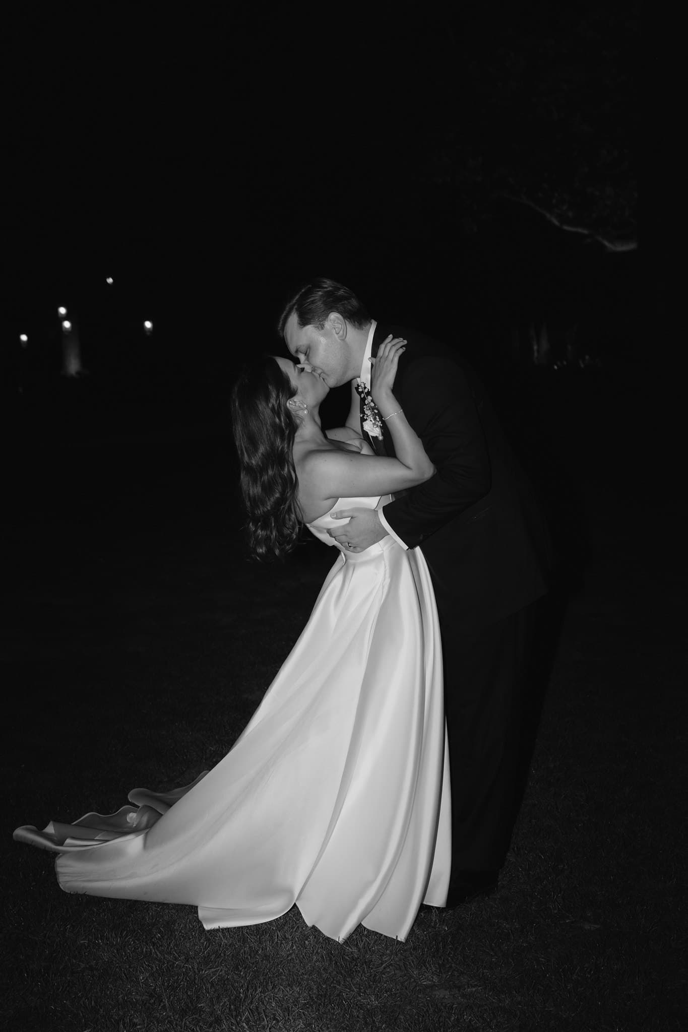 Bride and groom dancing outside