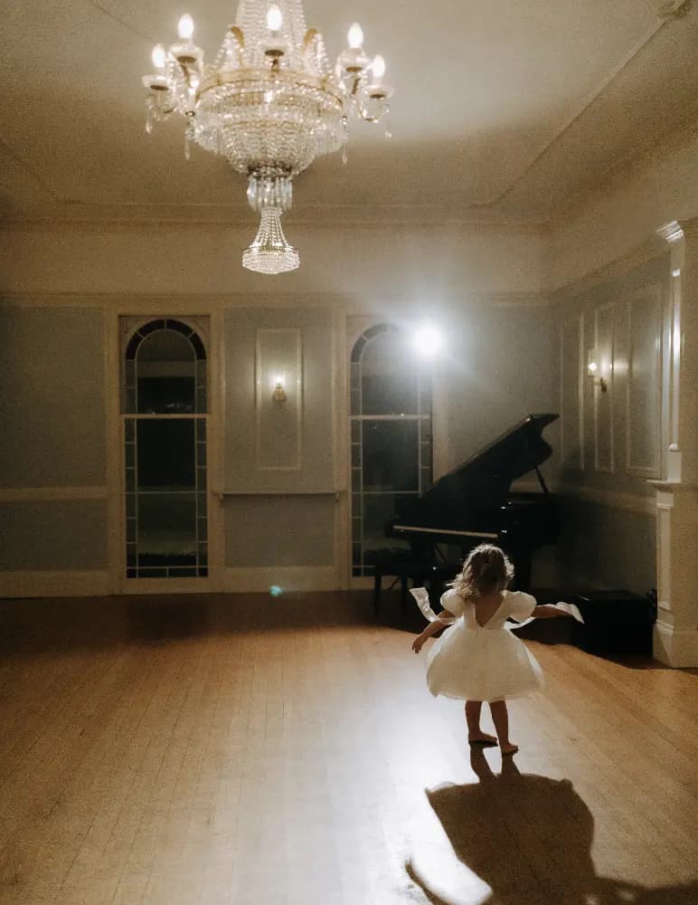 Little wedding guest dances in the ballroom