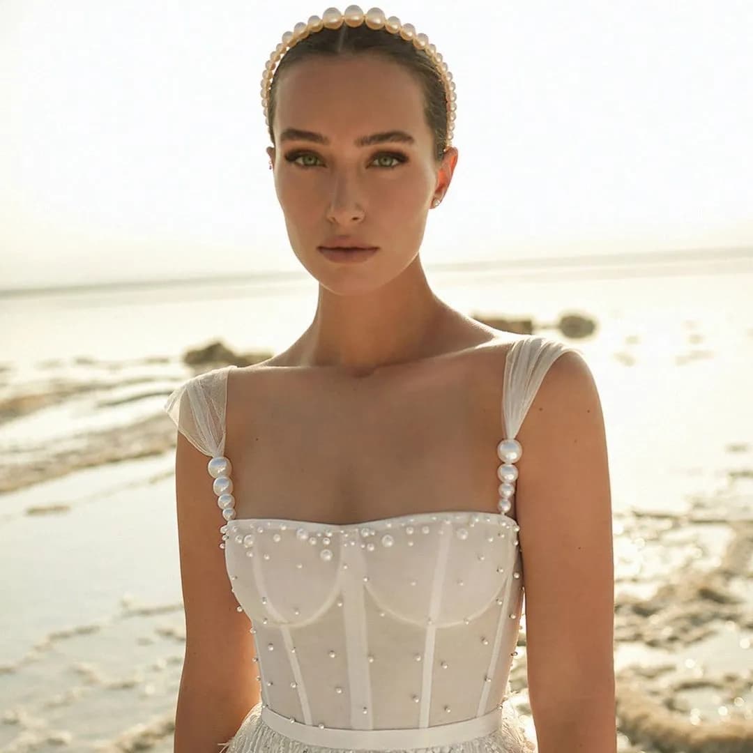 Bride in wedding dress with corset and pearl headband