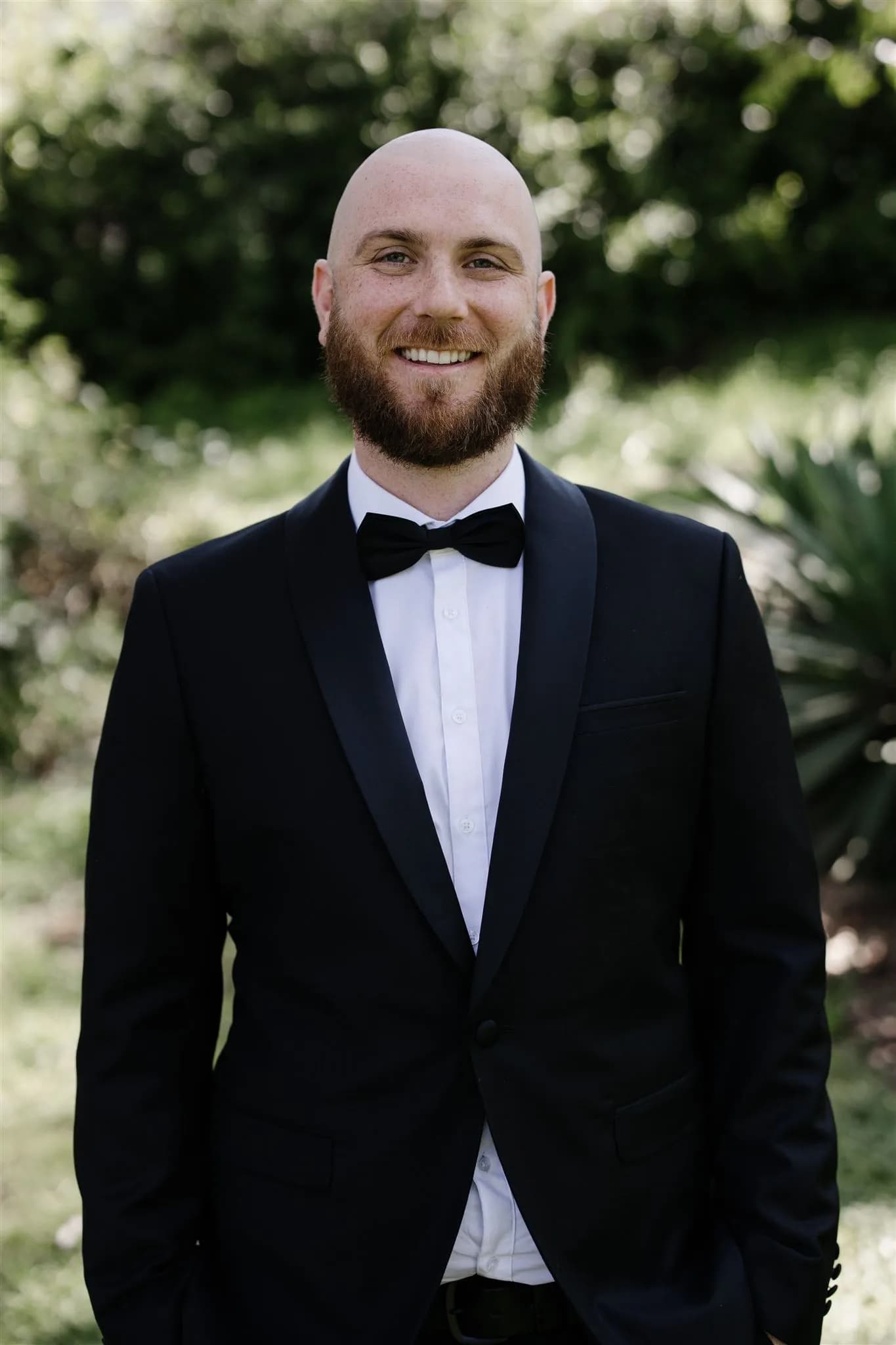 Groom standing in wedding jacket