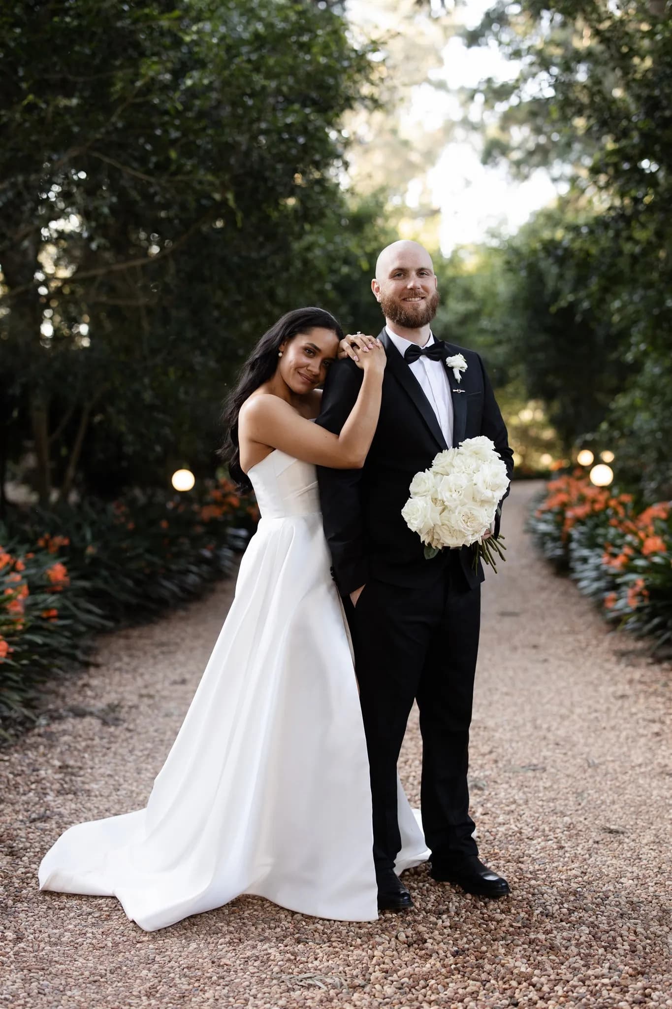 Bride and groom standing on driveway