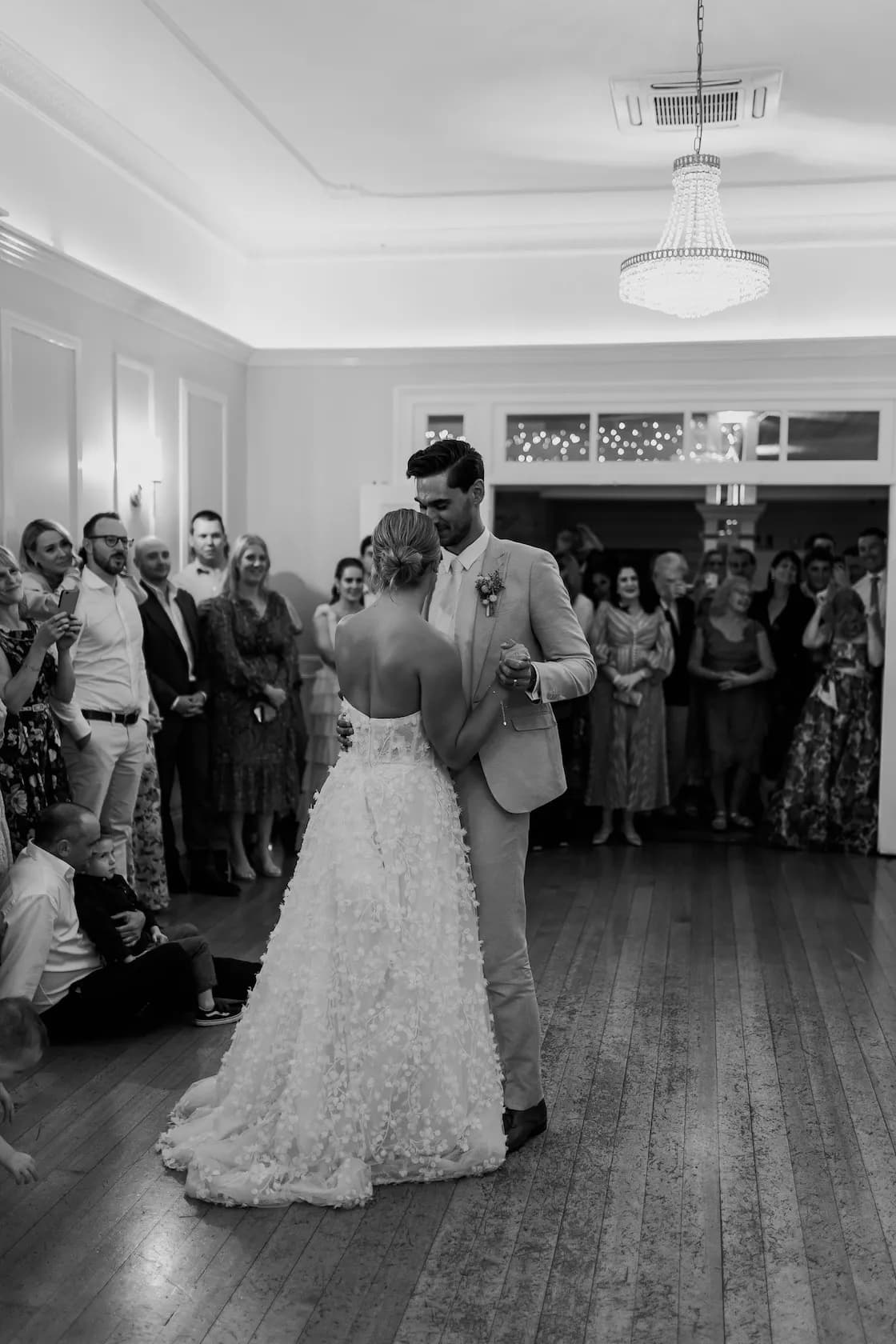 Bride and groom dancing in ballroom