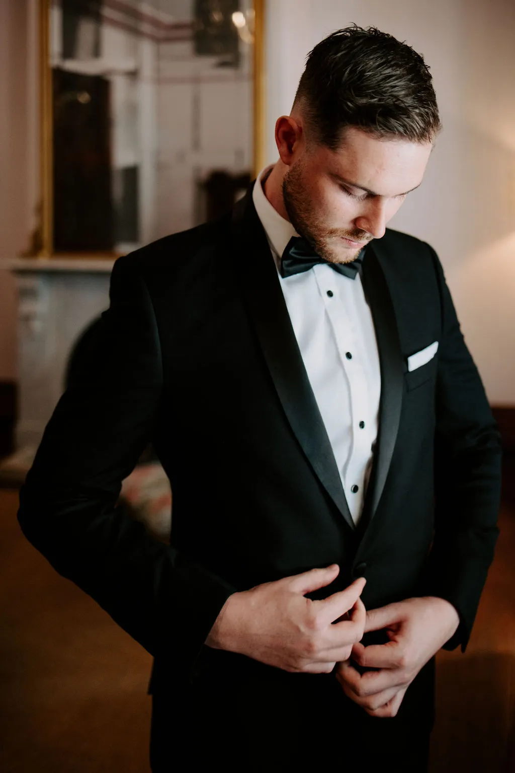 Groom doing up jacket