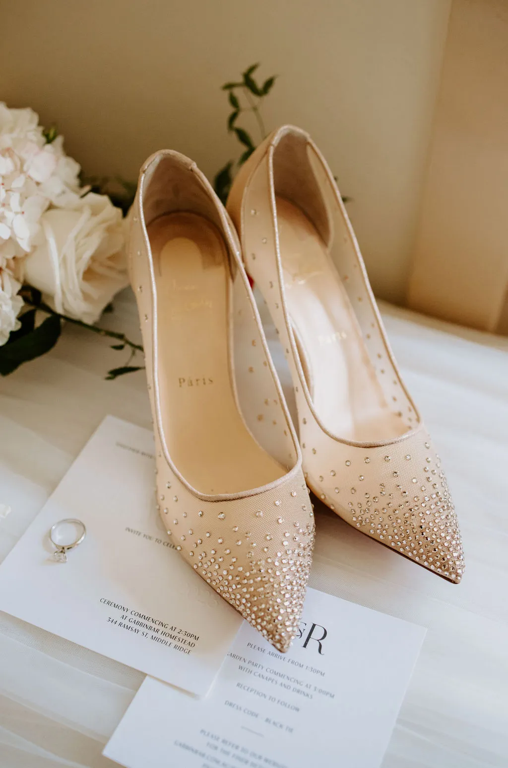 Brides wedding shoes and wedding invitations