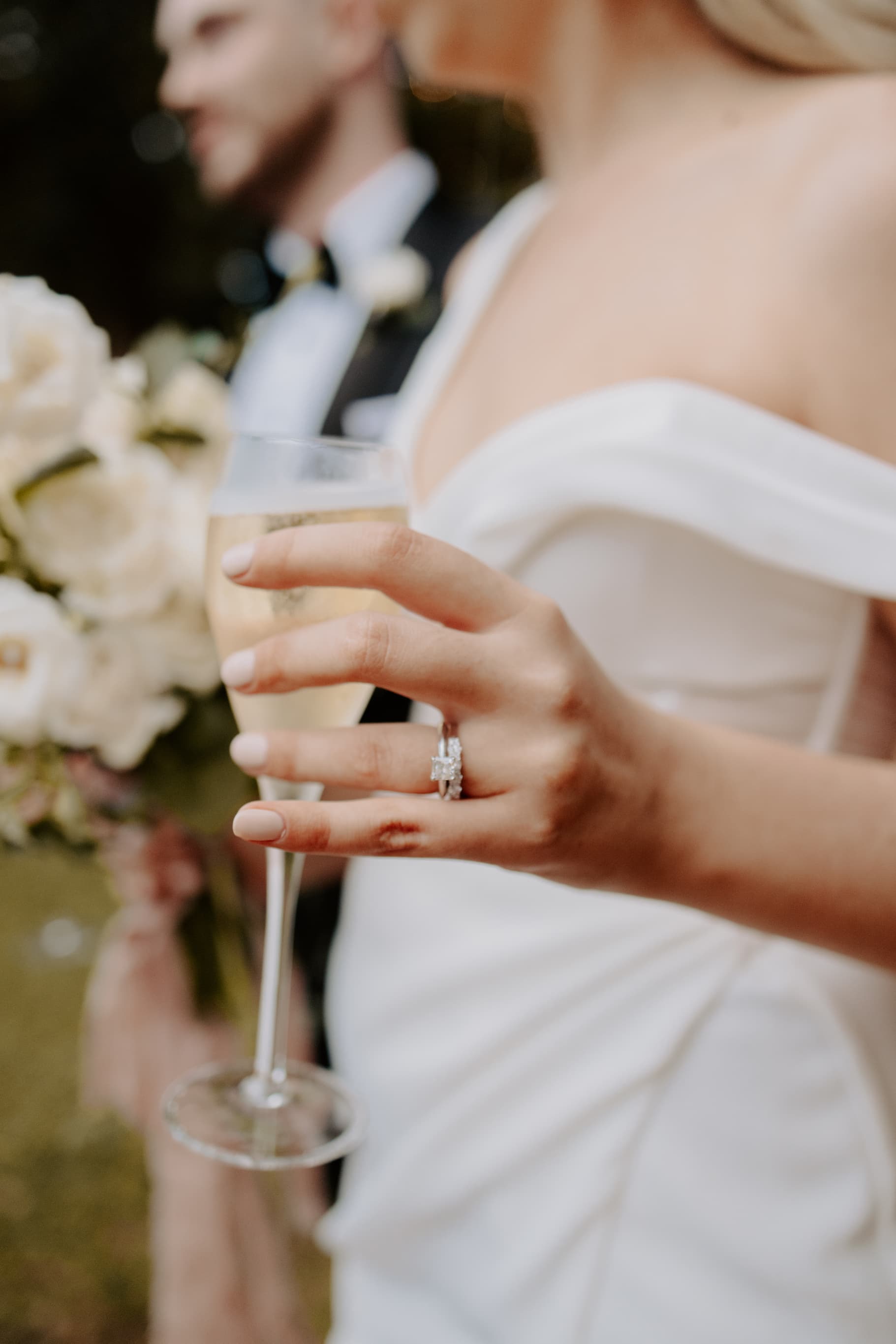 Bride holding glass of champagne