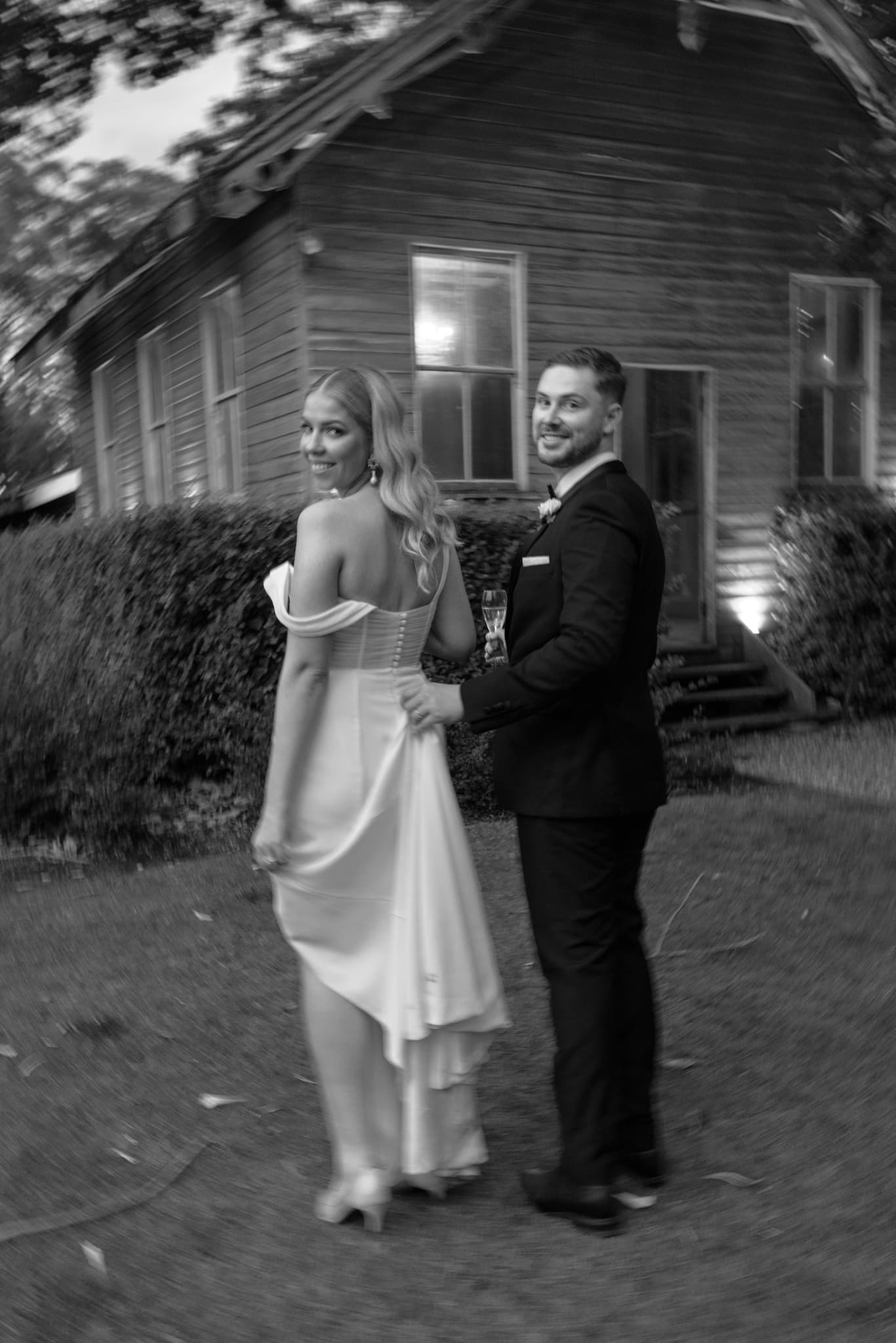 Bride and groom walking through gardens