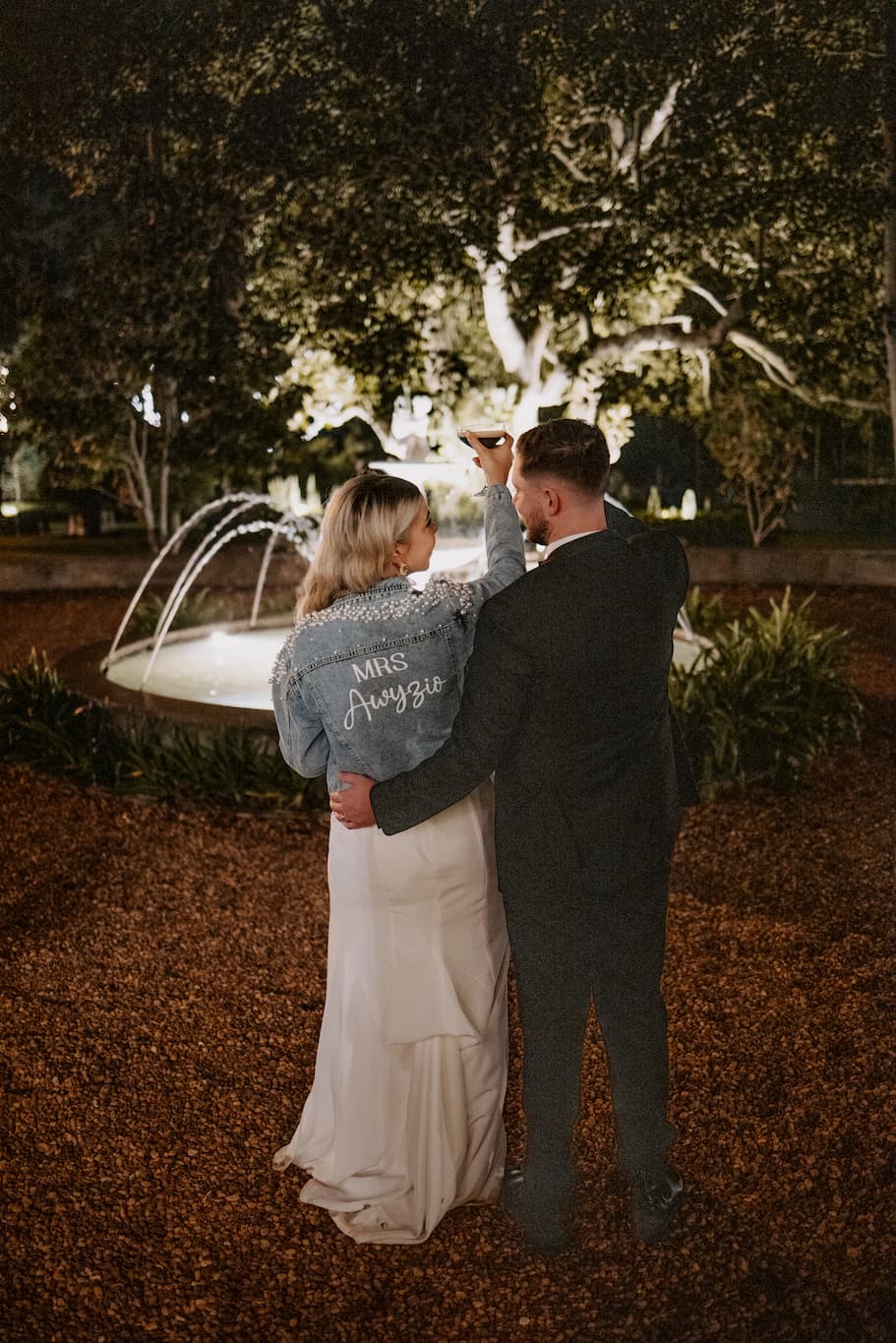 Bride and groom drinking cocktails outside