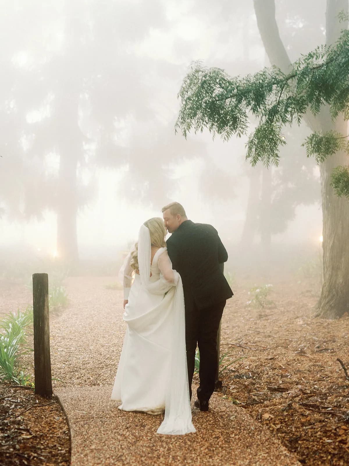 Bride and groom walking and kissing