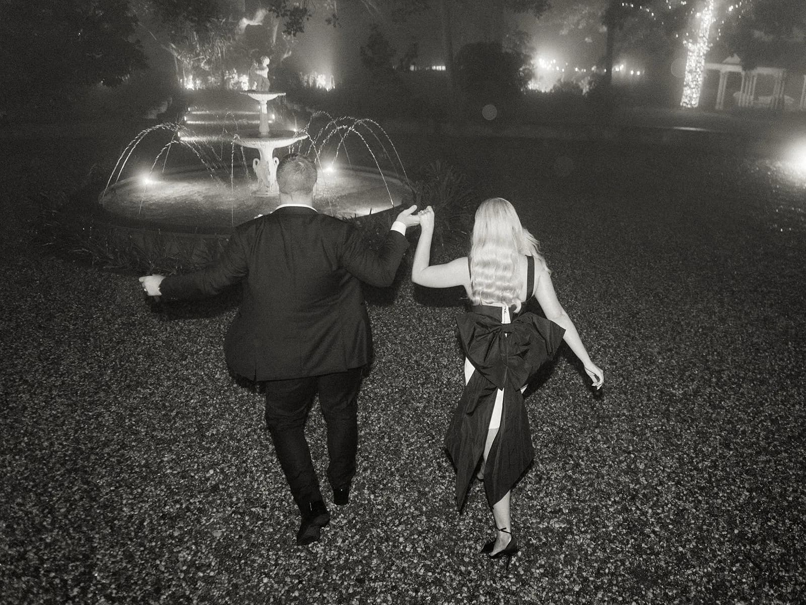 Bride and groom walking outside at nighttime