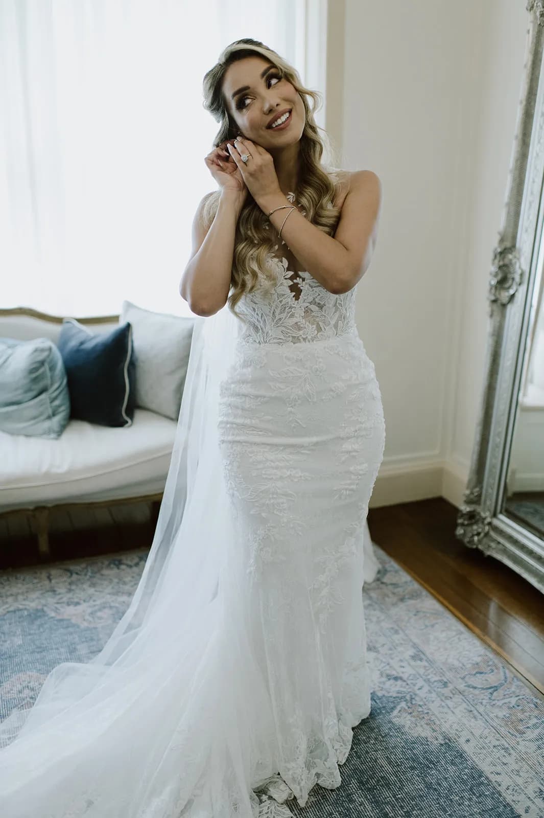 Bride putting in earrings