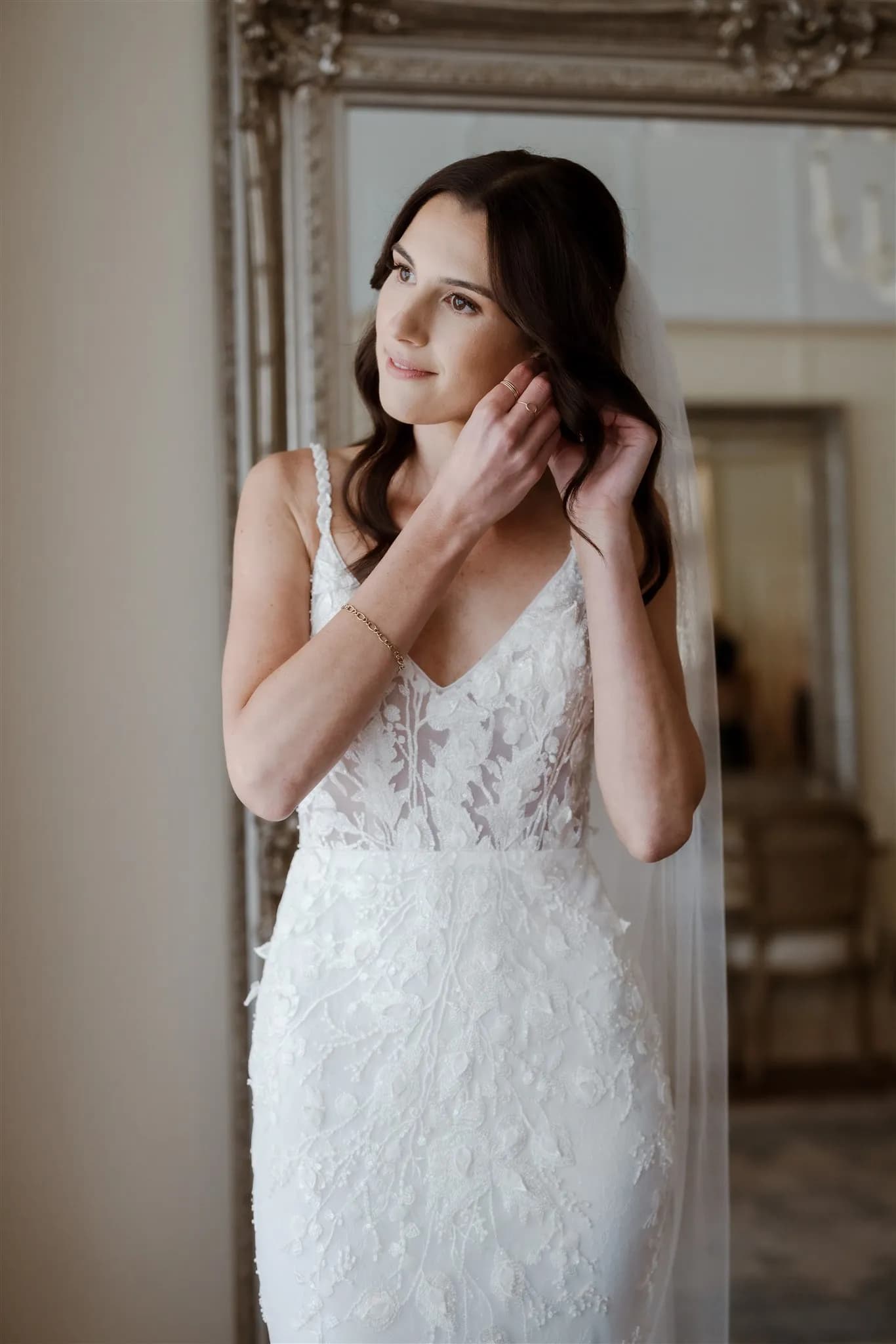 Bride putting in earring