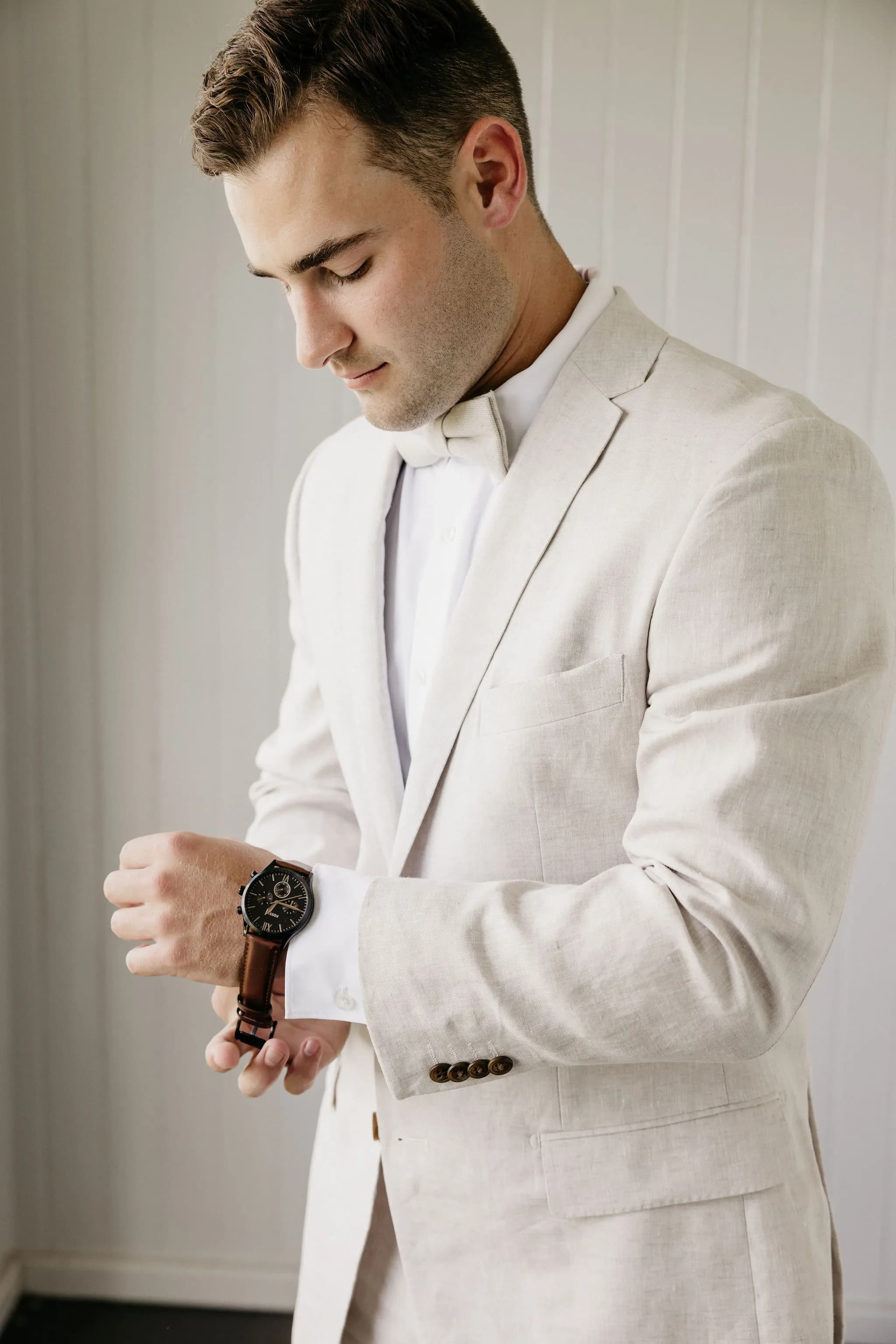 Groom putting on watch