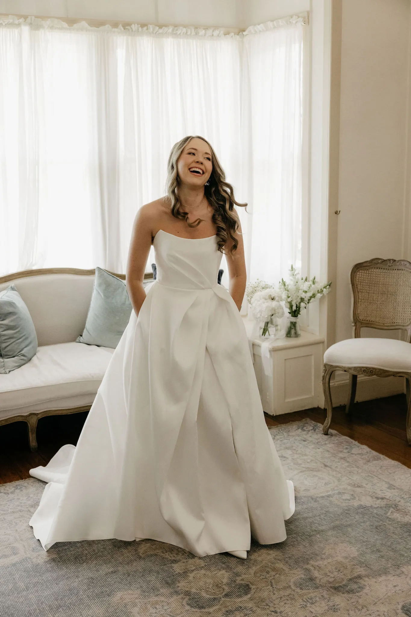 Bride laughing wearing wedding dress