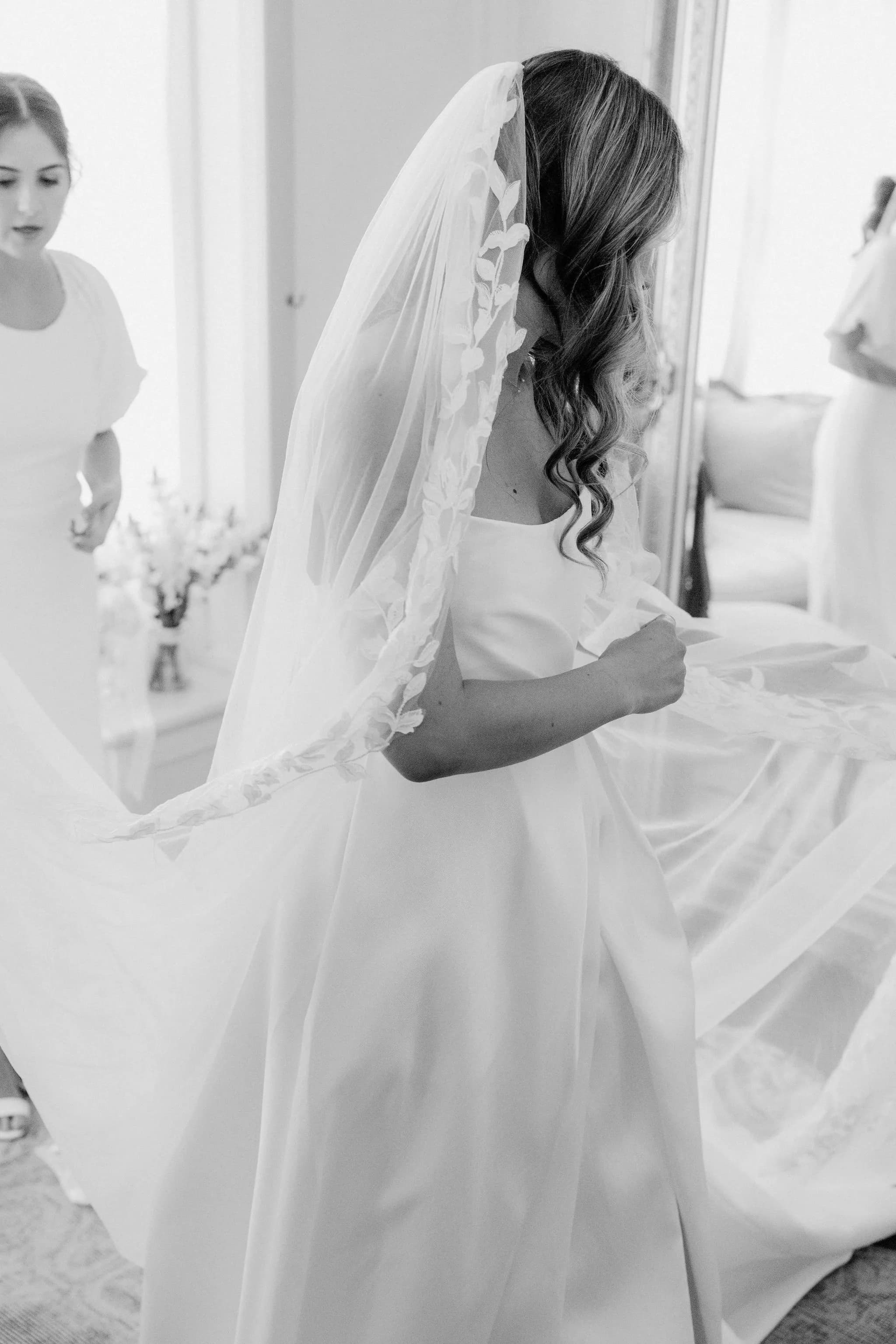 Bride putting on veil