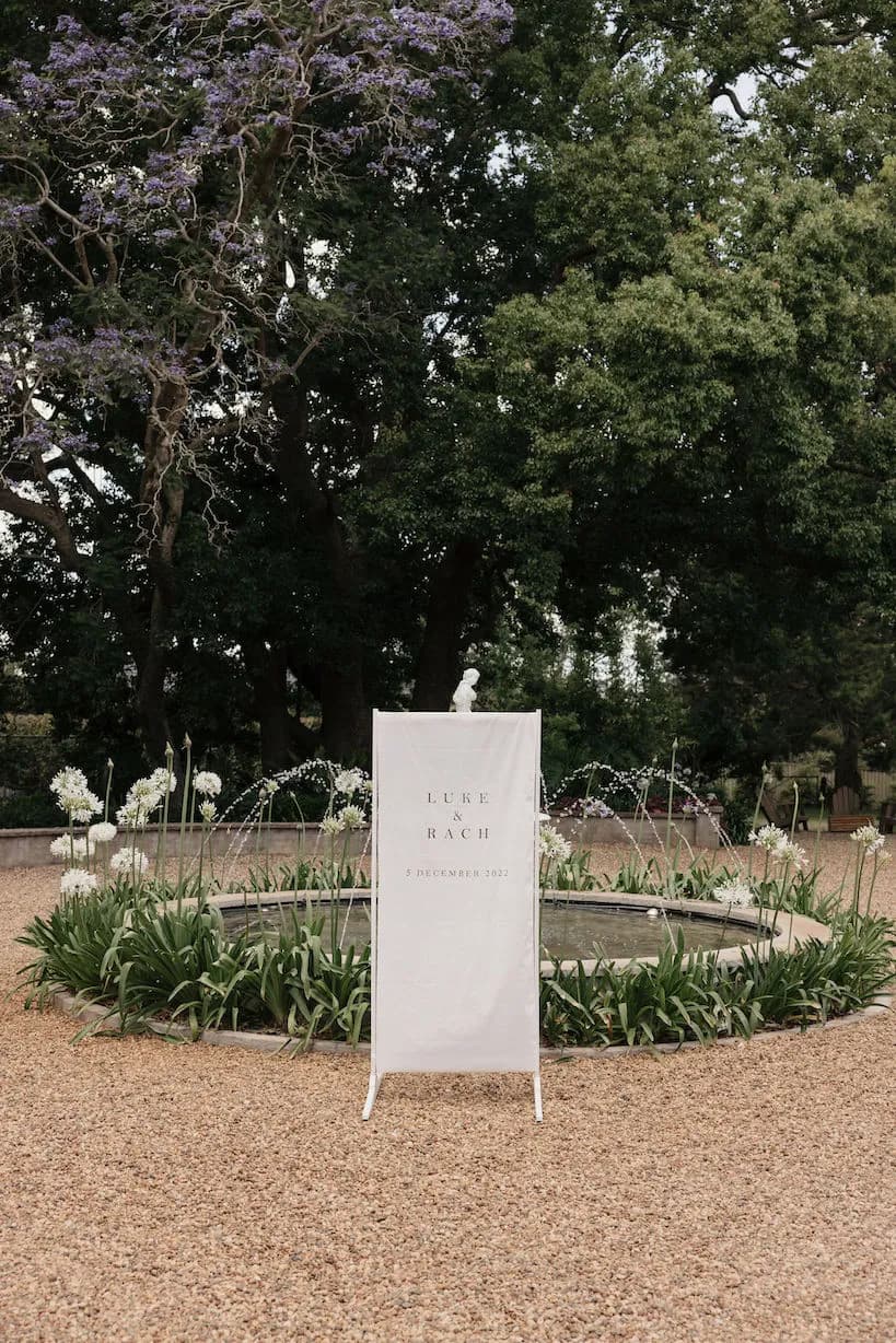 Wedding welcome sign in front of fountain