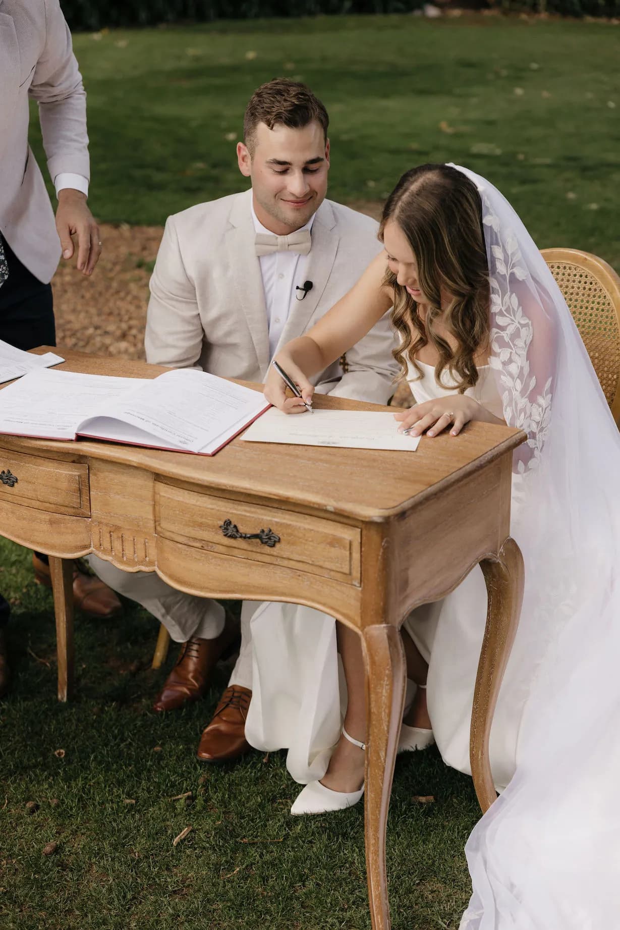 Bride and groom signing marriage certificate