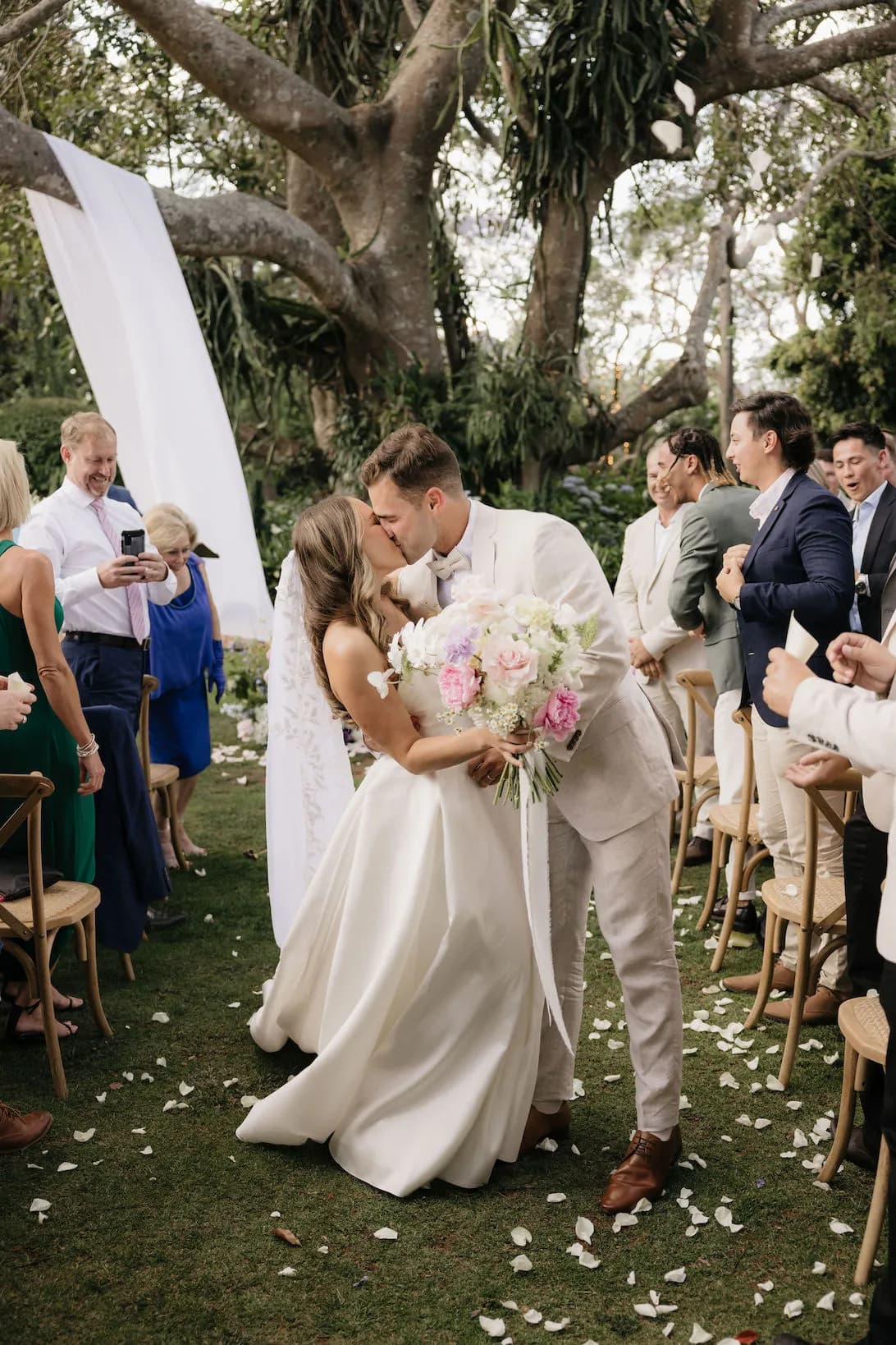 Bride and groom kissing in aisle