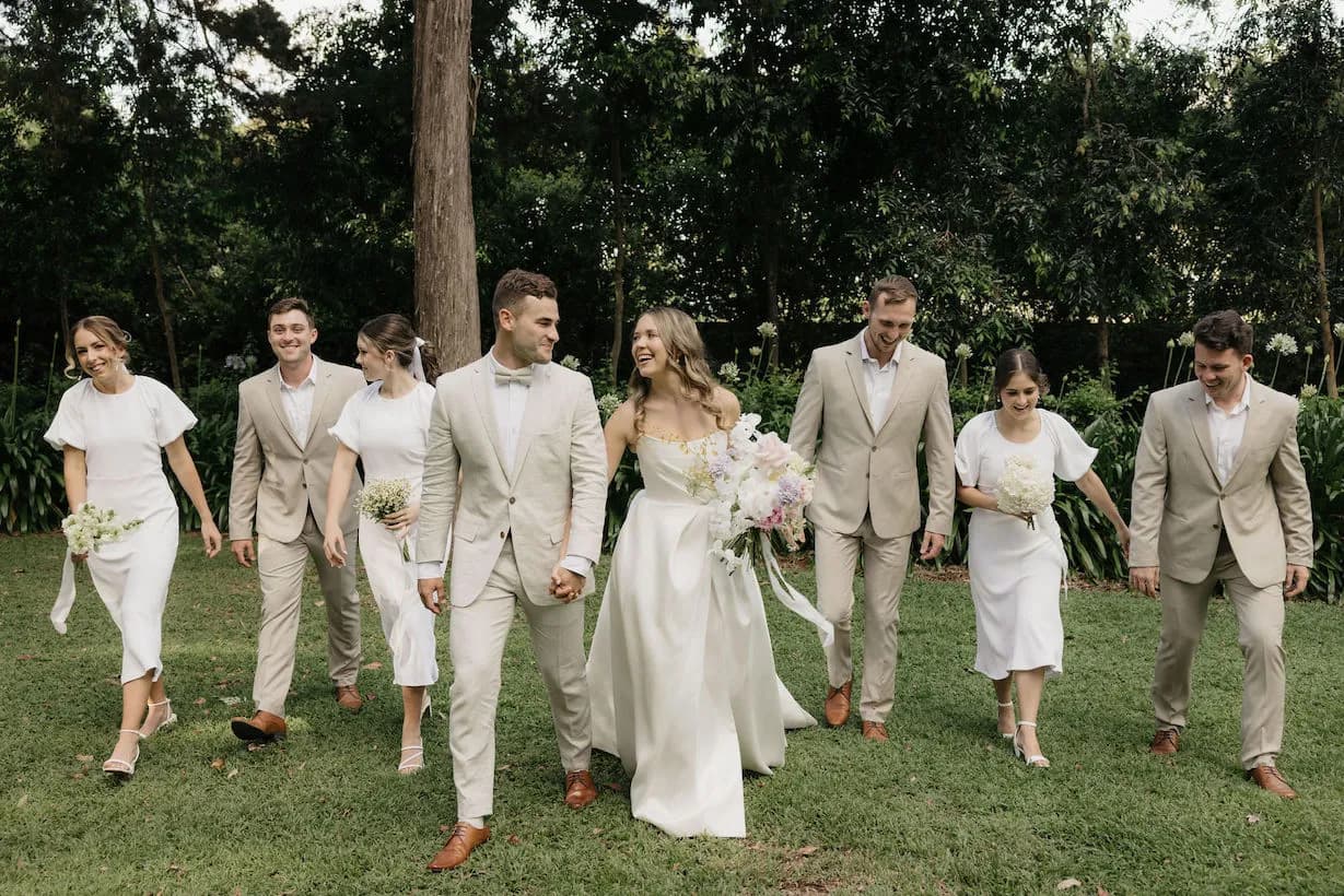 Wedding party walking in gardens