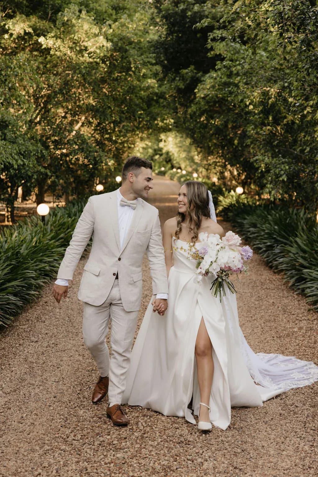 Bride and groom walking along holding hands