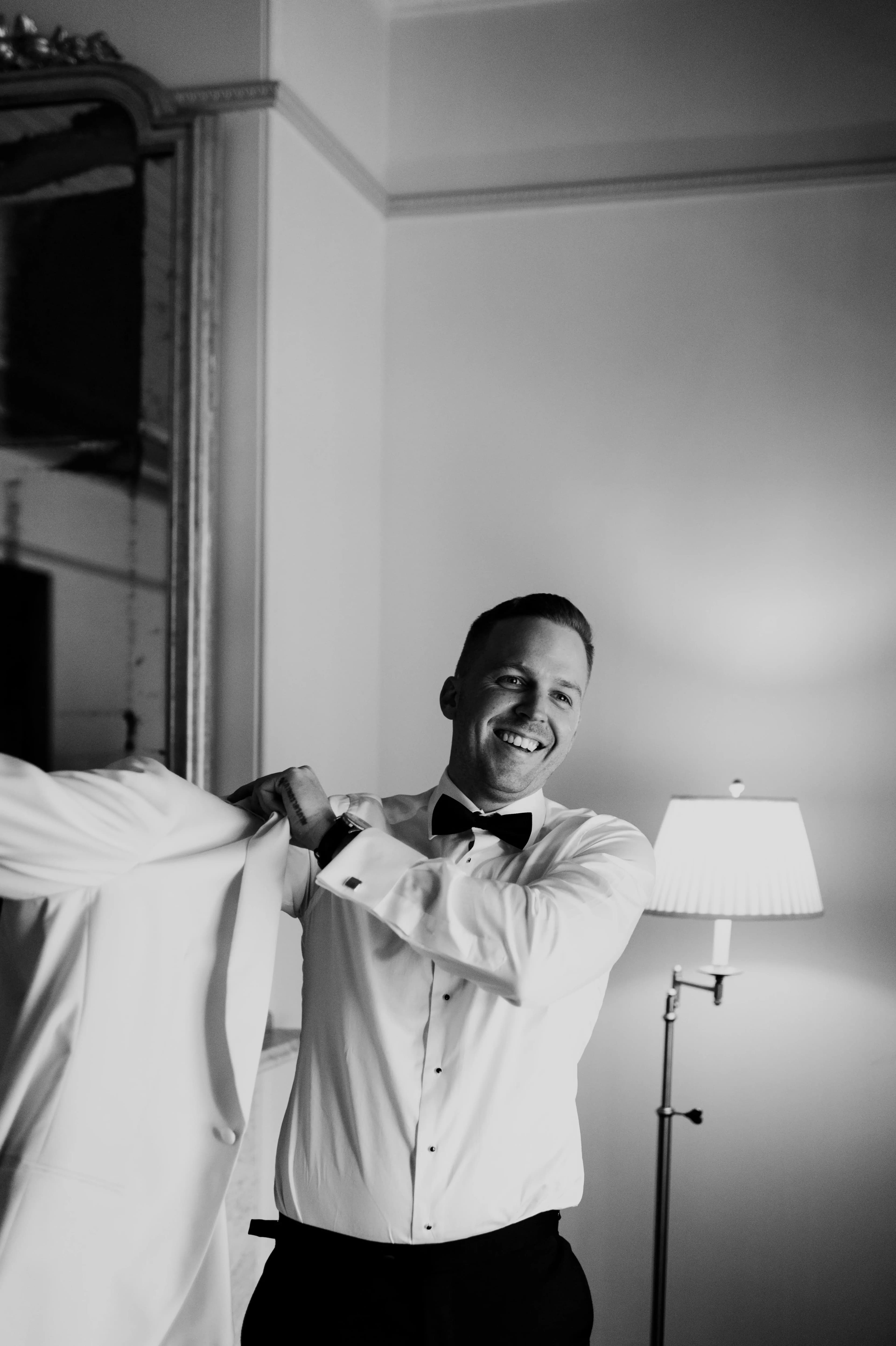 Groom put on wedding day jacket