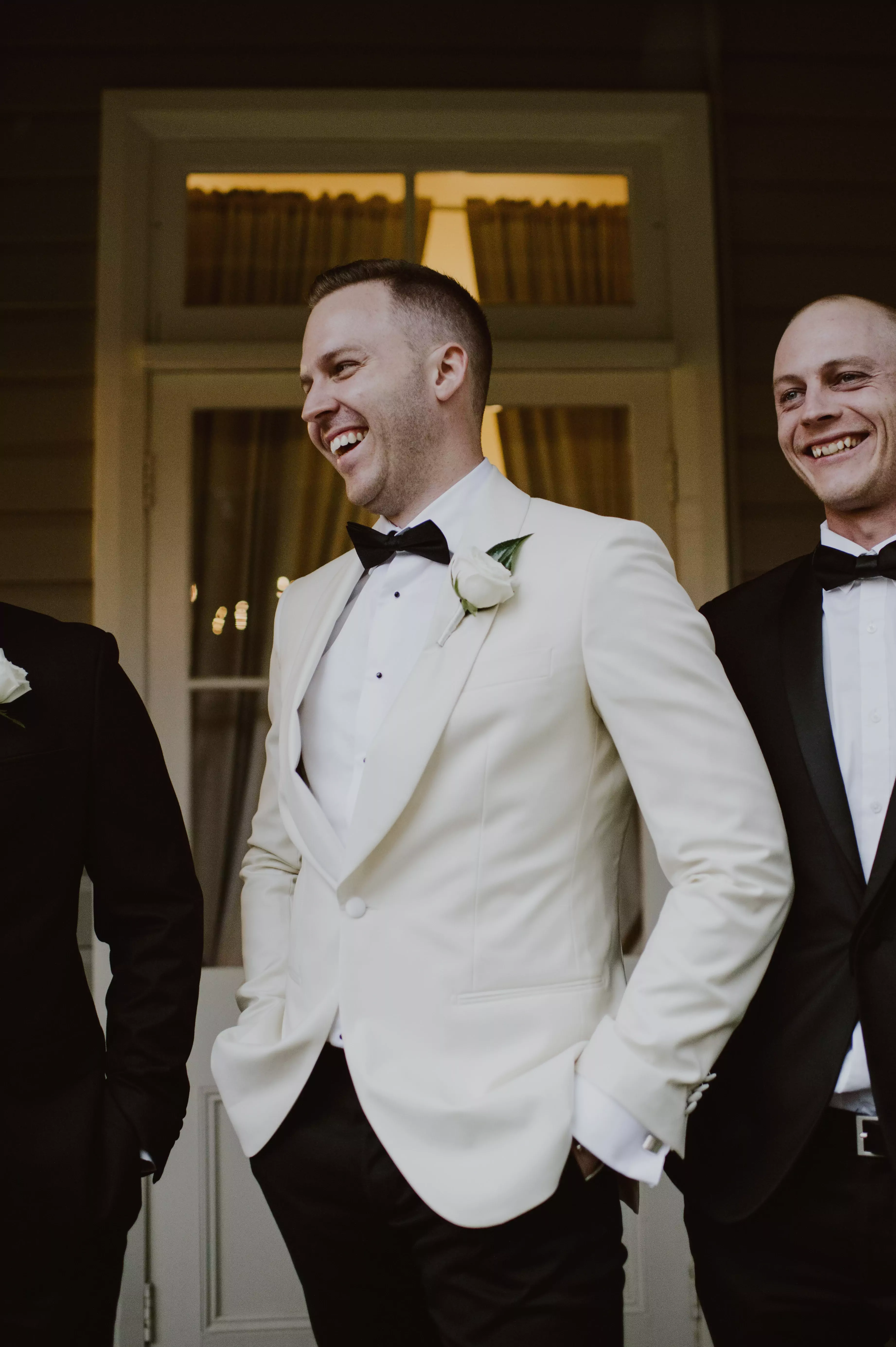 Groom laughs with groomsmen