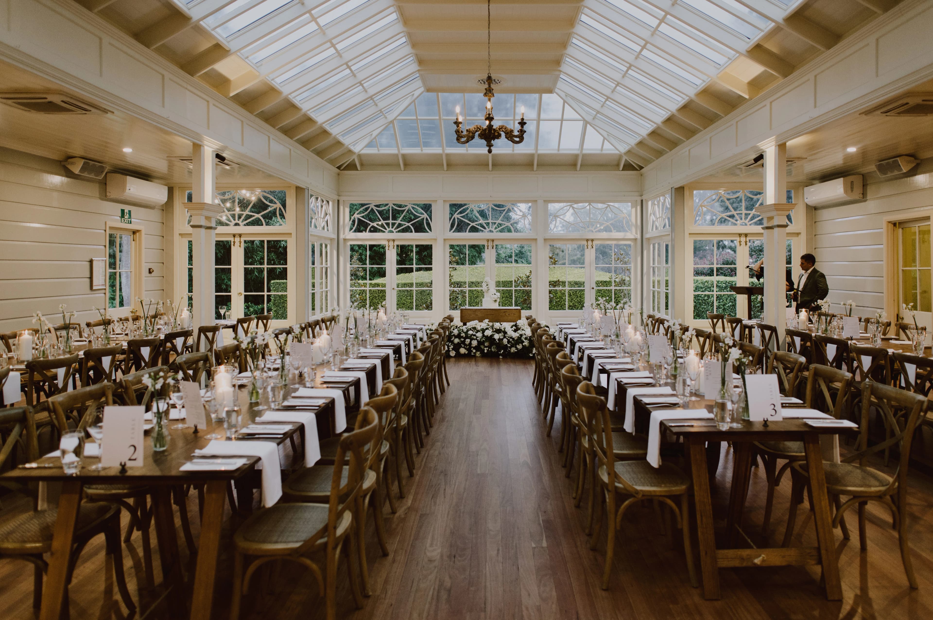 Country wedding reception with timber top tables and white linen