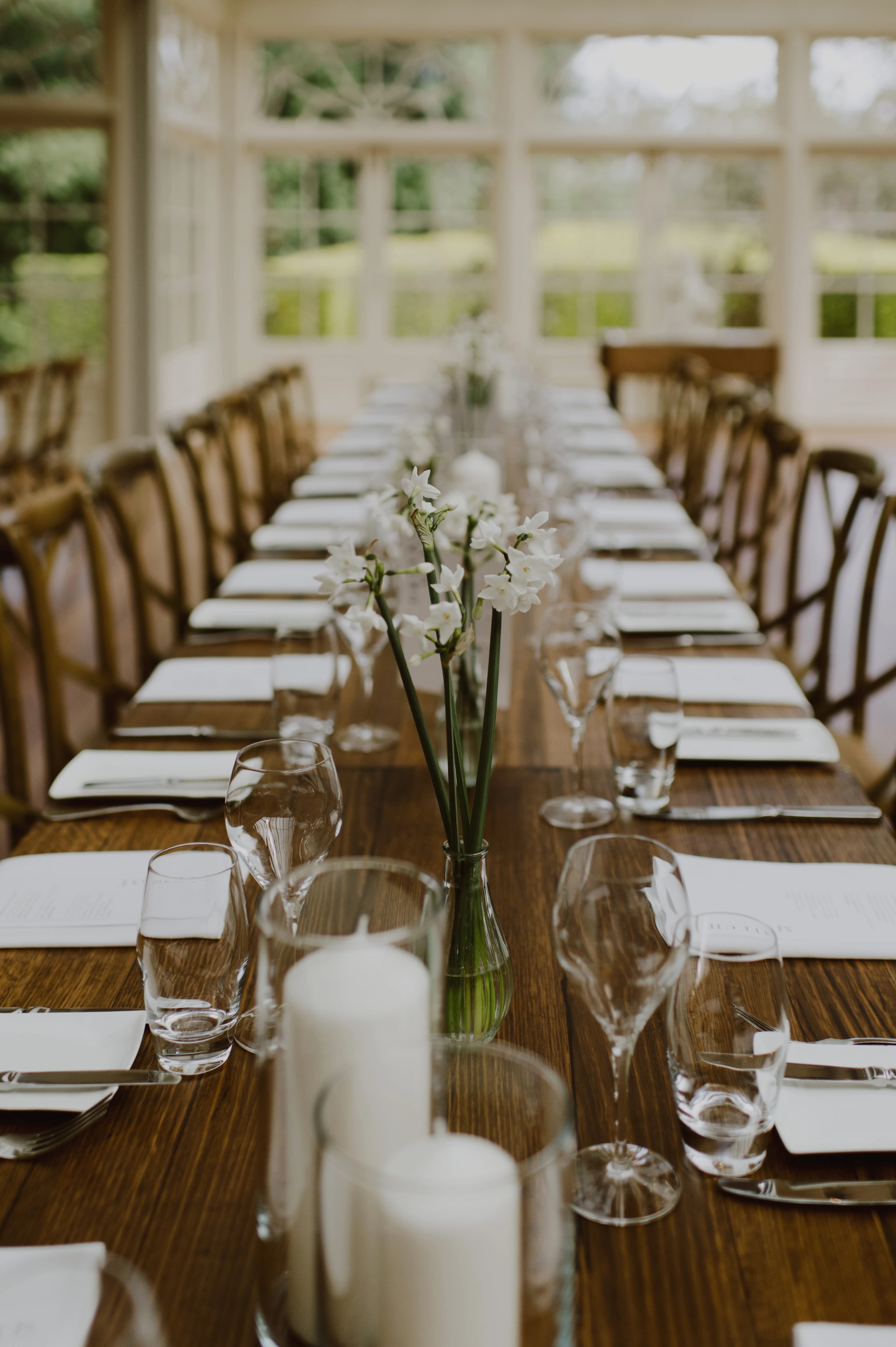 Reception styling with timber tables and daffodil bud vases