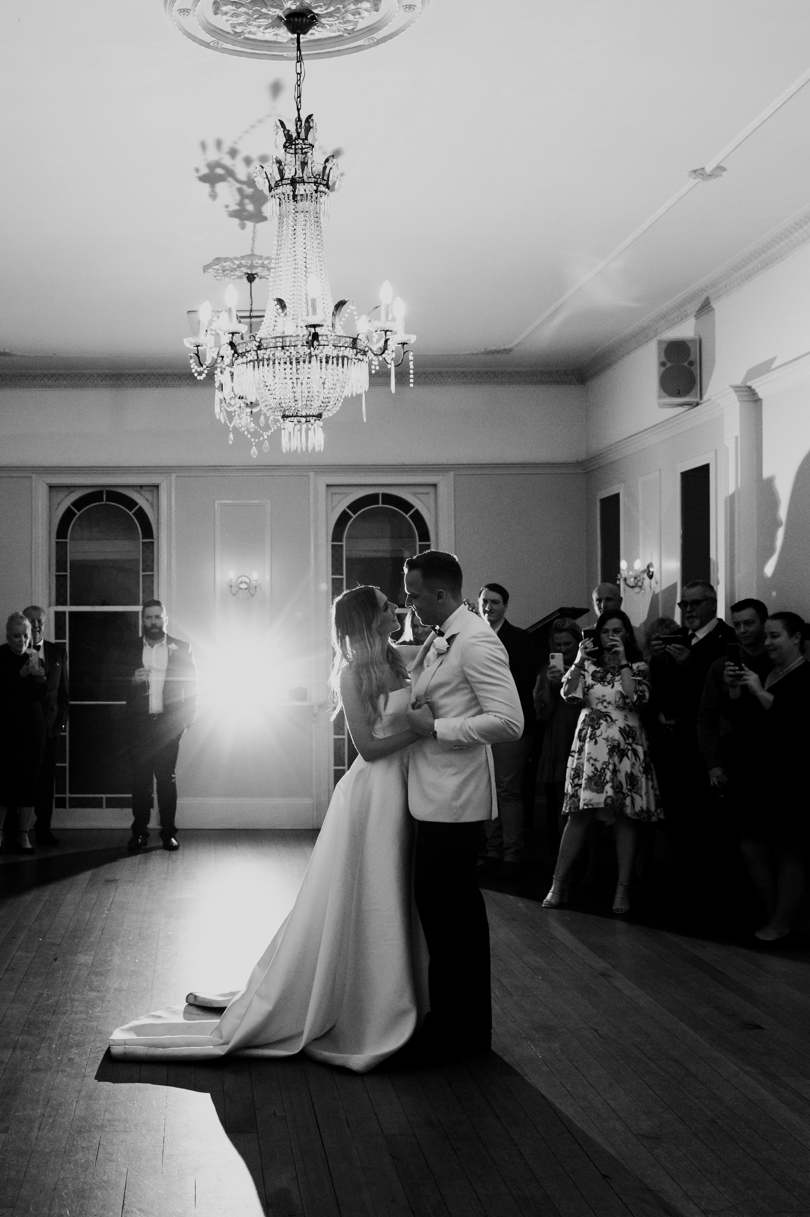 Couple dance in the ballroom as guests watch on in wonder