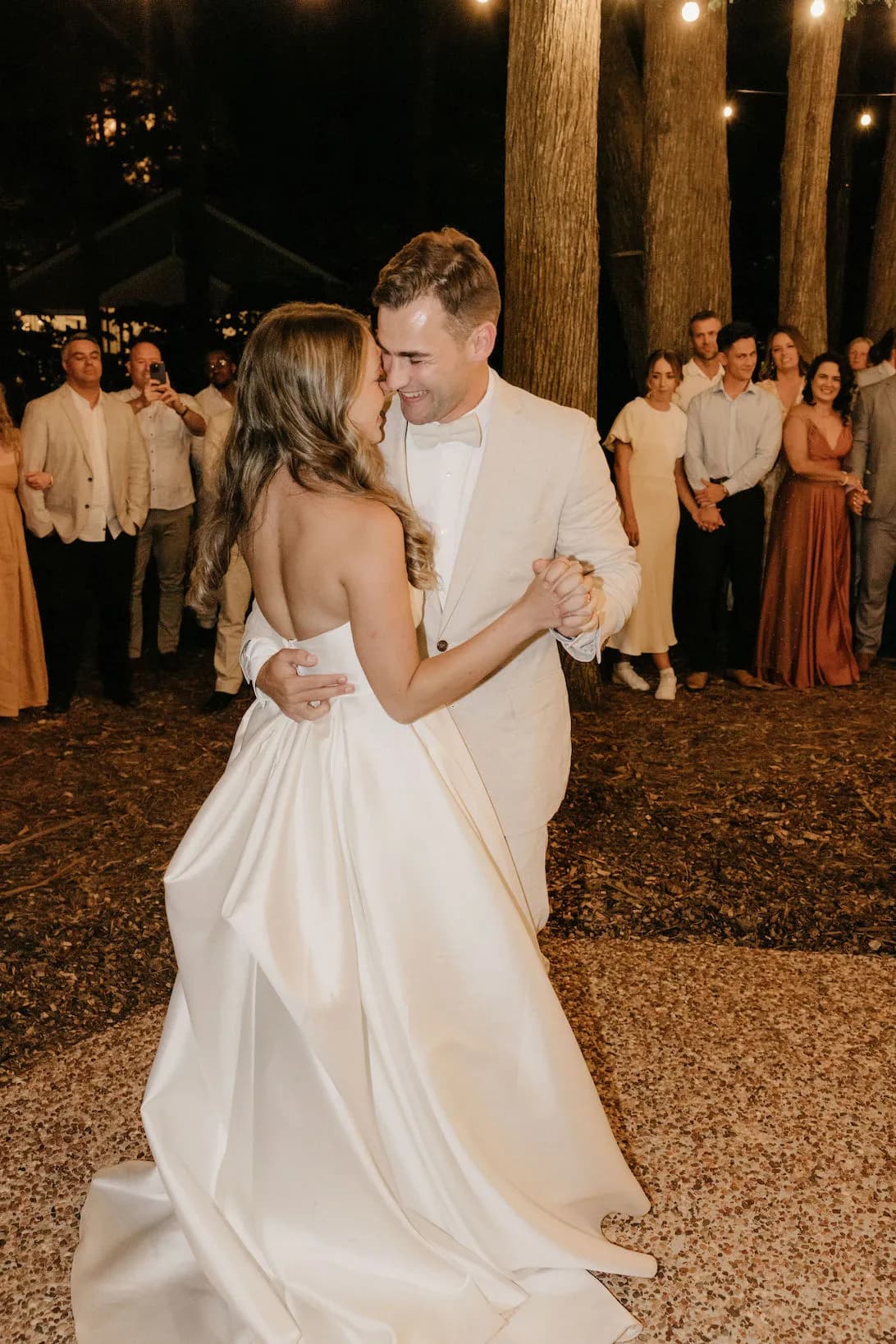 Bride and groom dancing in woods