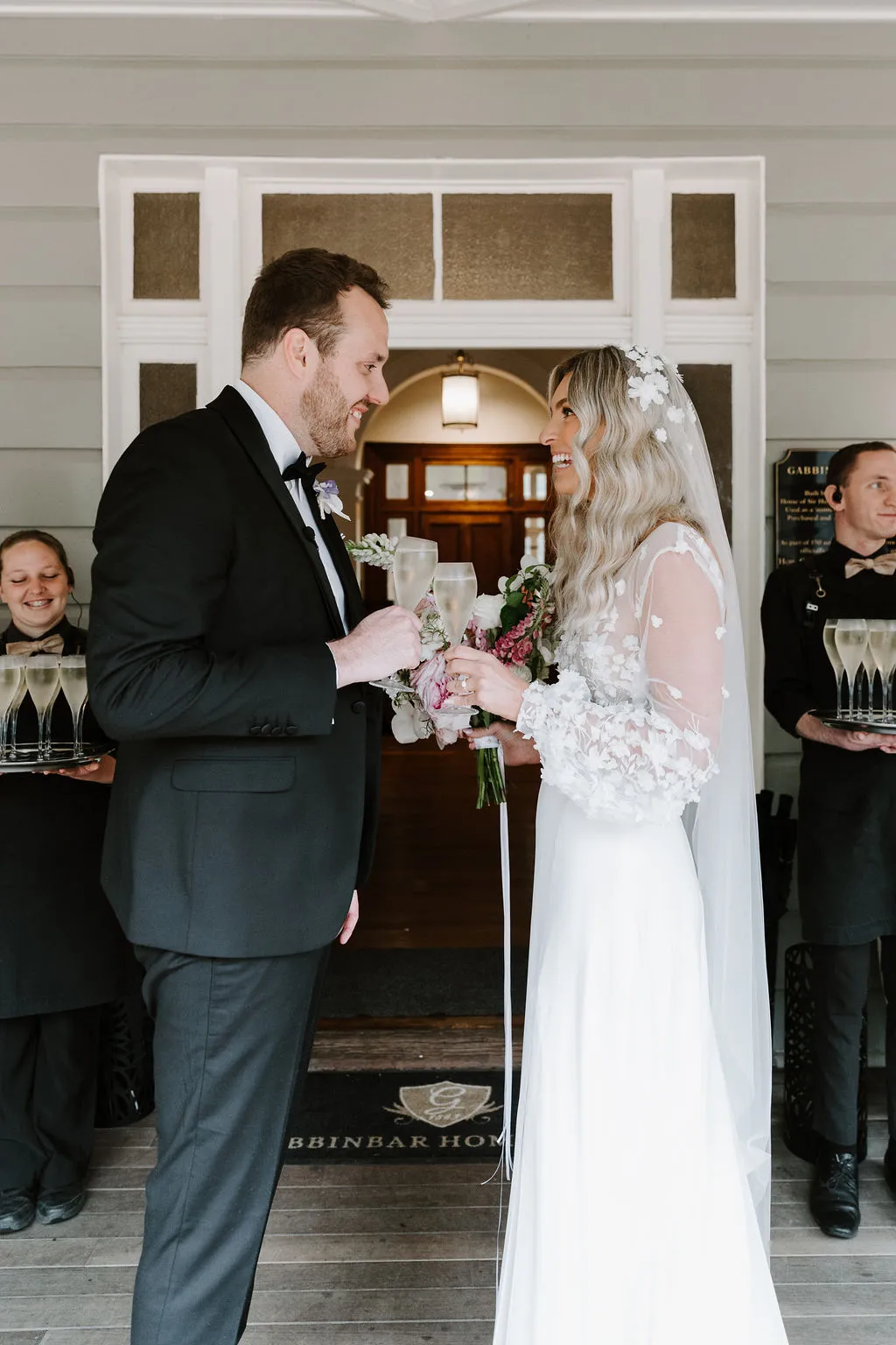 Bride and groom standing in front of door