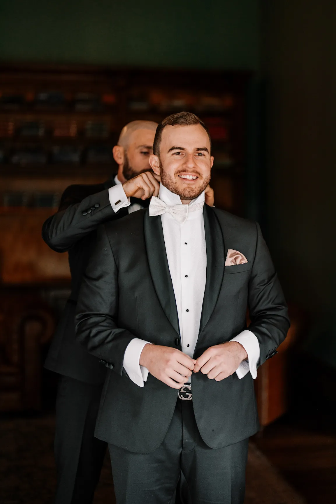 Groom getting into suit