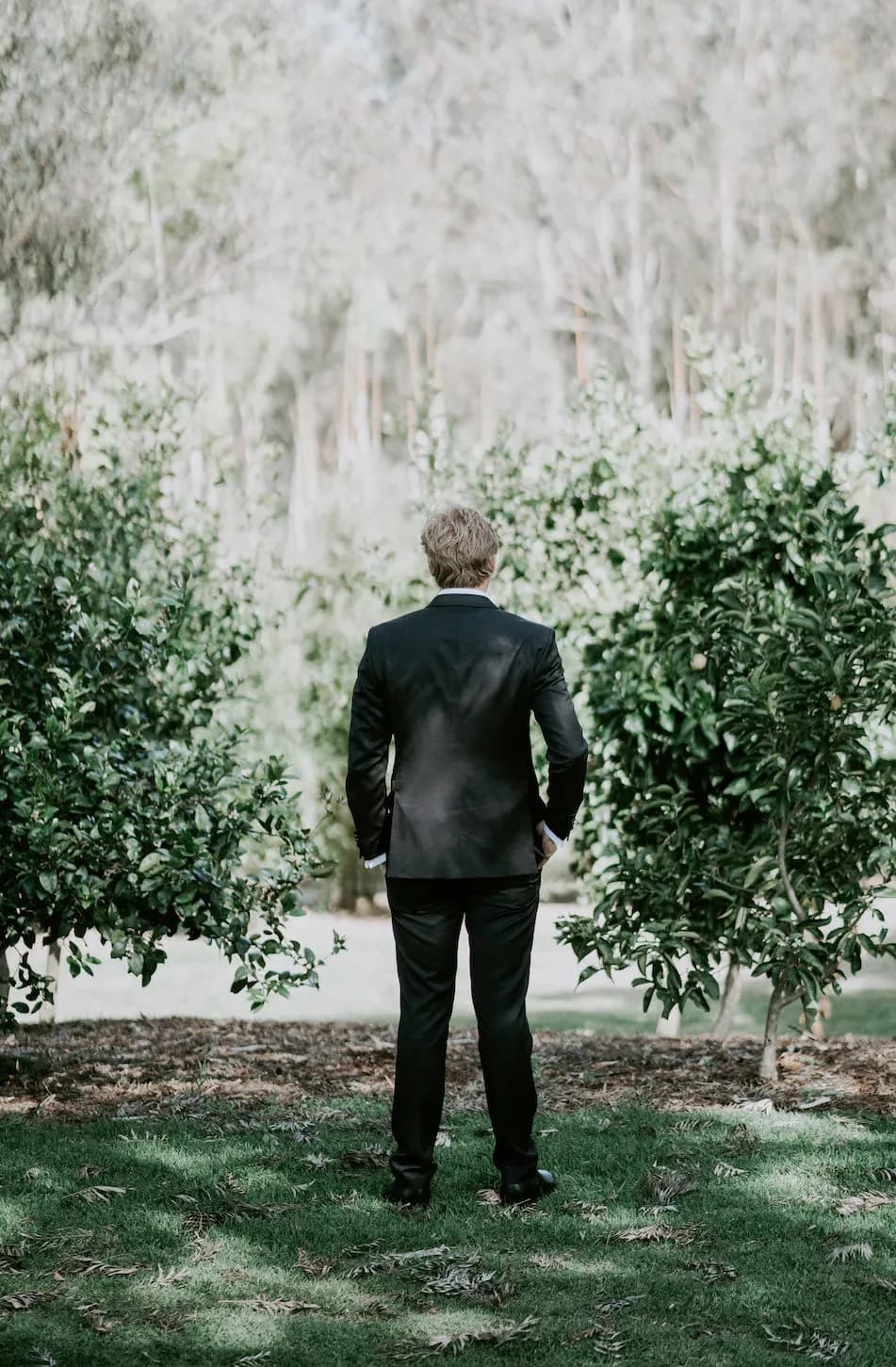 Groom standing in gardens