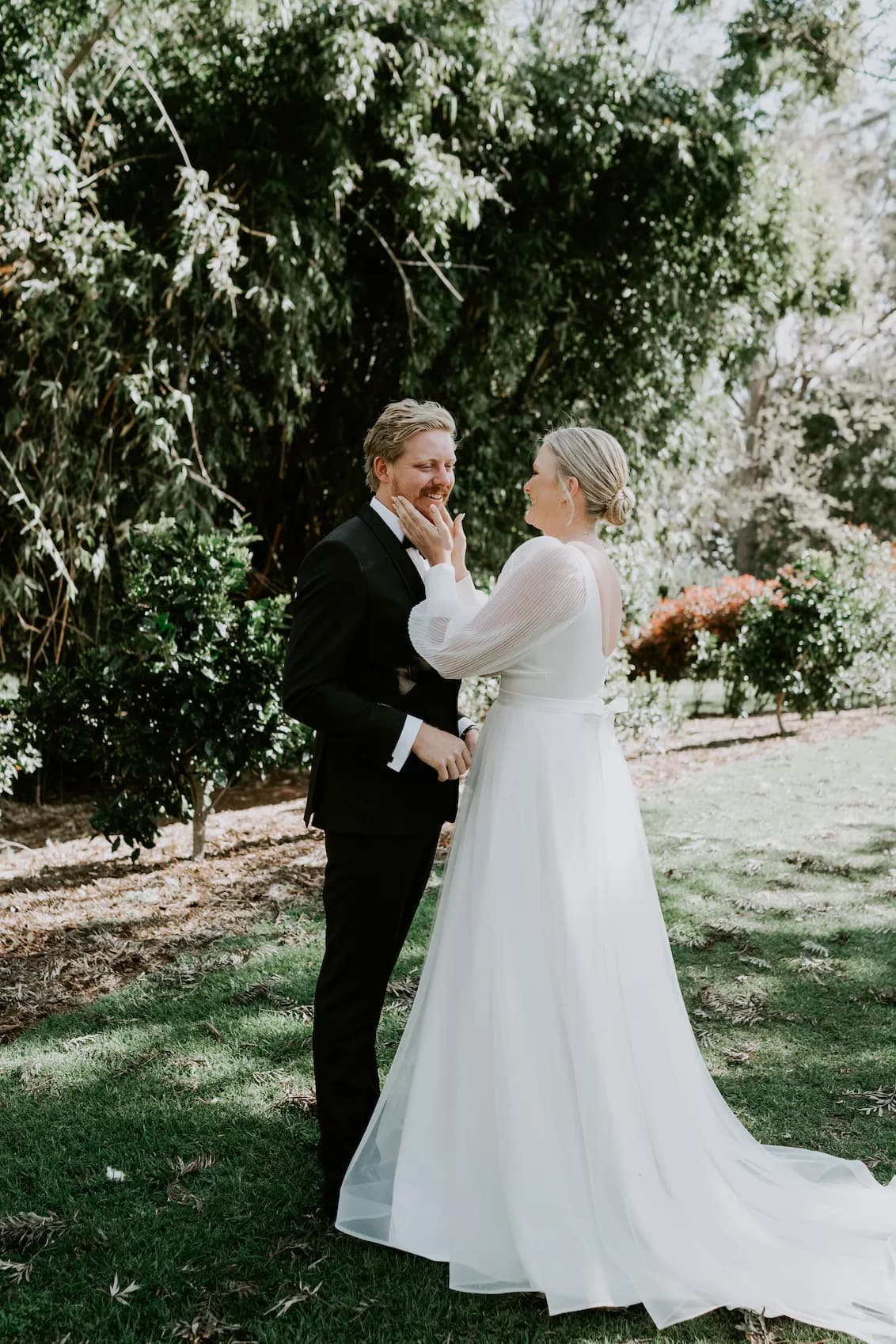 Bride and groom hugging in gardens