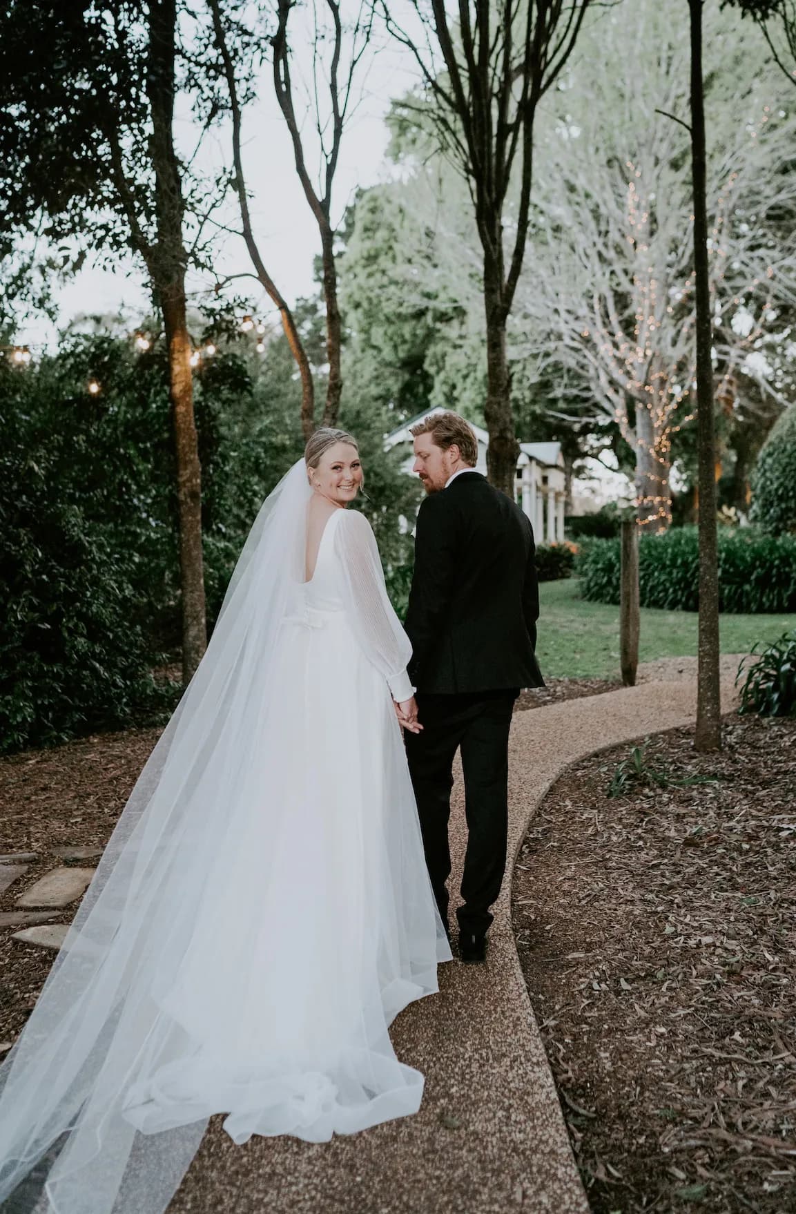 Bride and groom walking in gardens