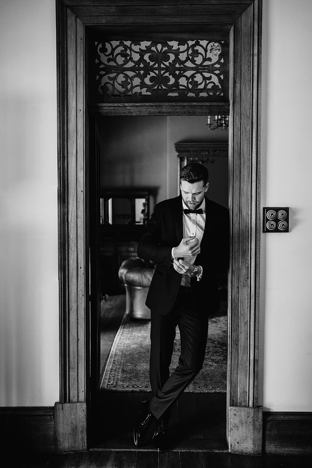 Groom standing in doorway