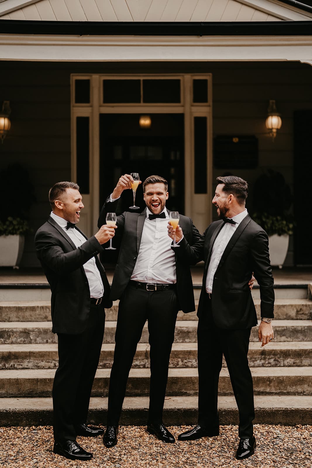 Groom and groomsman drinking juice